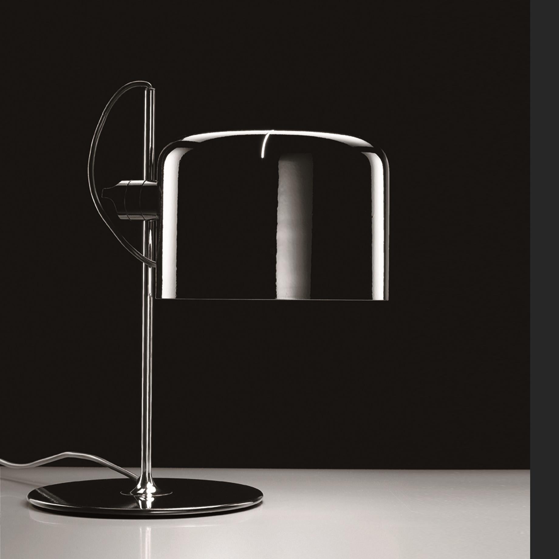 Table lamp 'Coupé' designed by Joe Colombo in 1967.
Table lamp giving direct light, lacquered metal base, chromium-plated stem, adjustable reflector in lacquered aluminium.
Manufactured by Oluce, Italy.

The Coupé series, designed by Joe