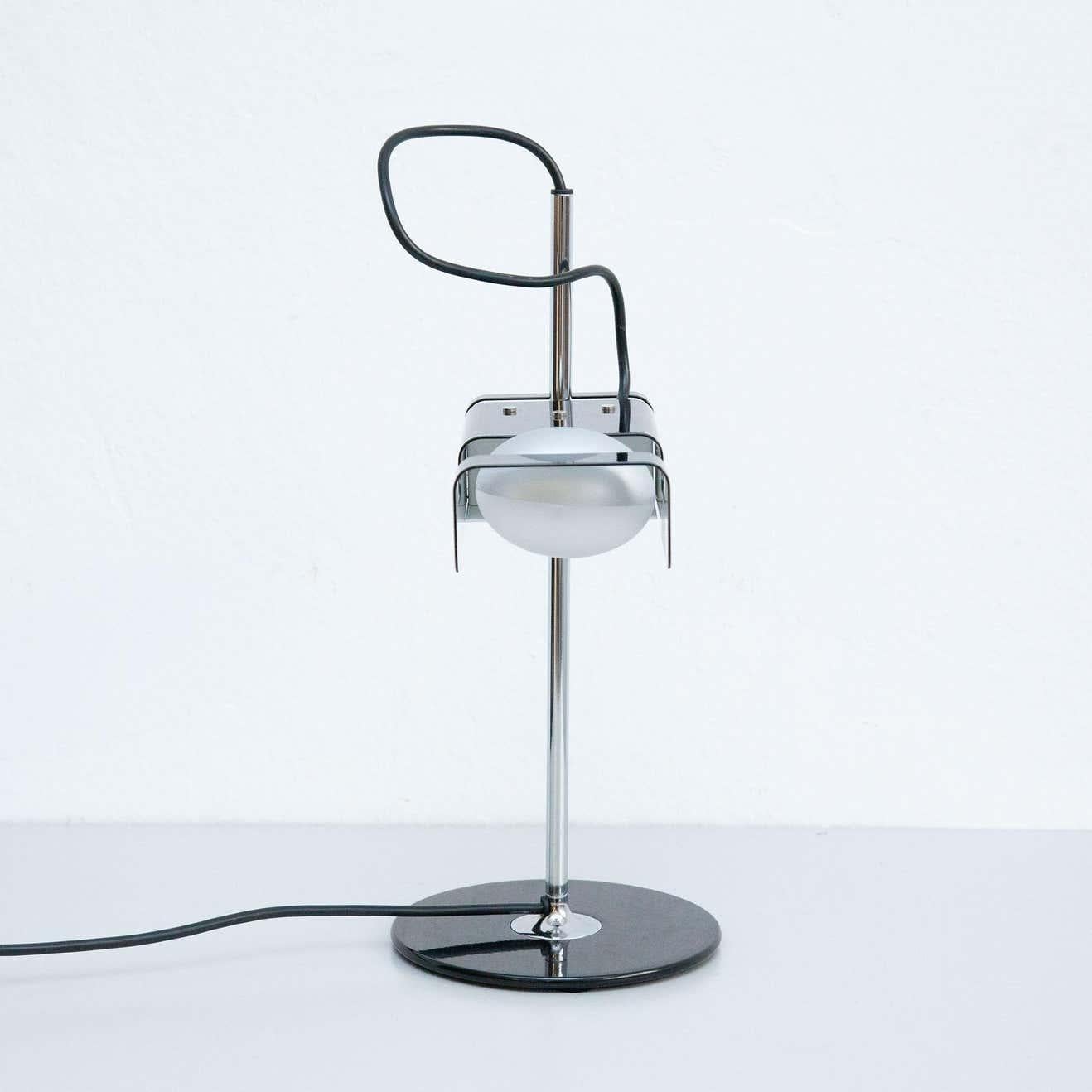 Table lamp 'Spider' designed by Joe Colombo in 1965.
Table lamp giving direct light, lacquered metal base, chromium-plated stem, adjustable reflector in lacquered aluminium. Manufactured by Oluce, Italy.

Table lamp with stove-enameled sheet