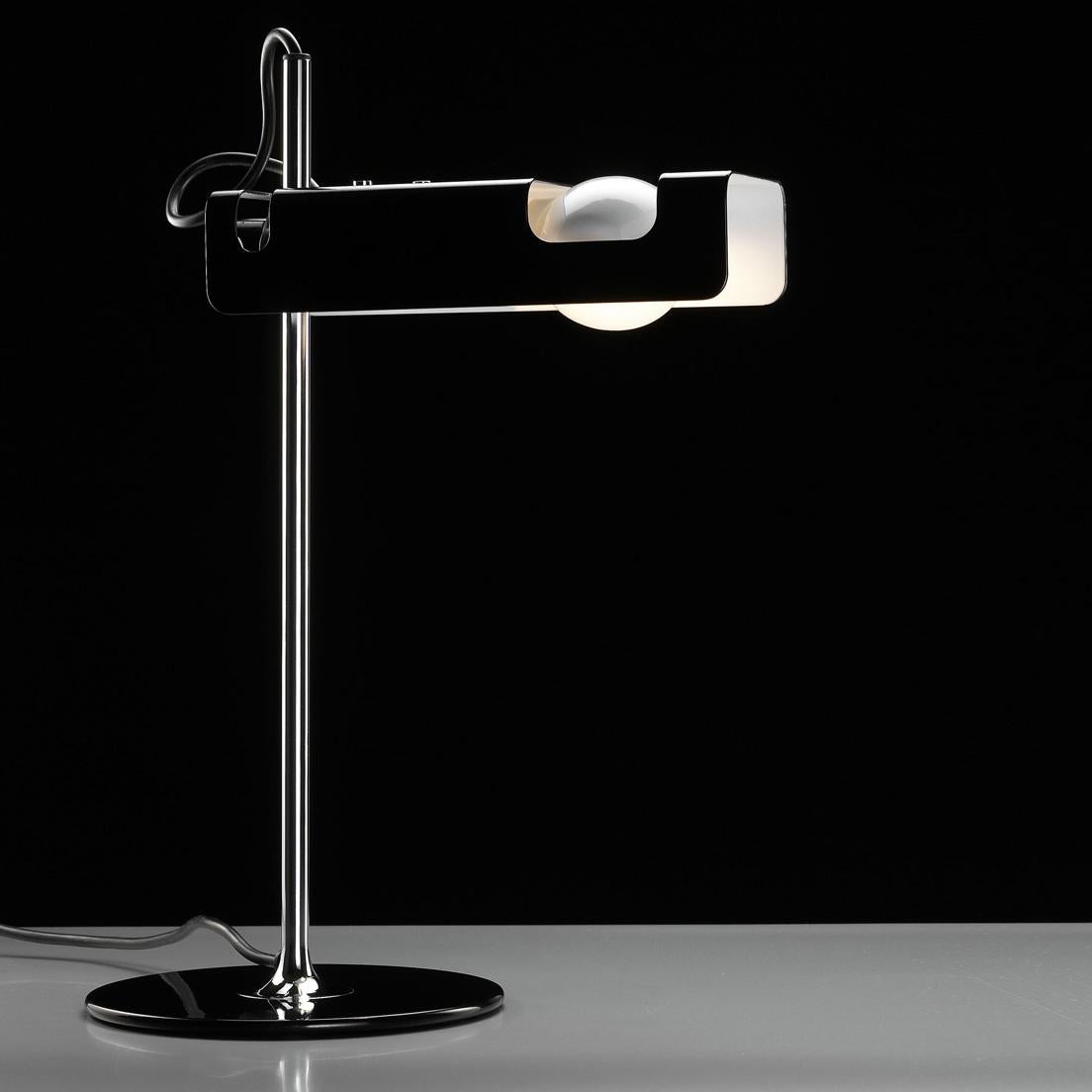 Table lamp 'Spider' designed by Joe Colombo in 1965.
Table lamp giving direct light, lacquered metal base, chromium-plated stem, adjustable reflector in lacquered aluminium.
Manufactured by Oluce, Italy.

Table or floor lamp with stove-enameled
