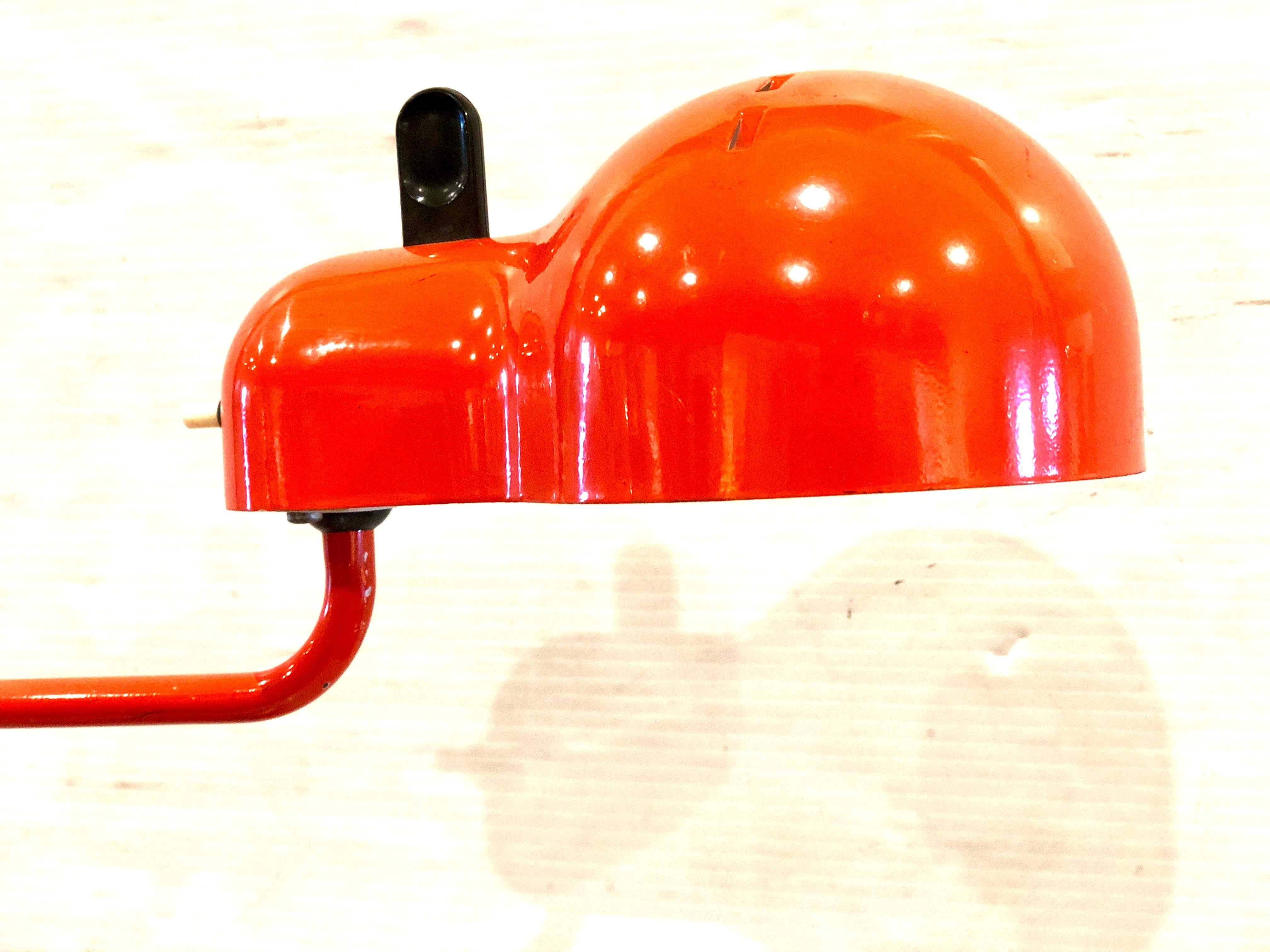 Joe Colombo 'Topo' task light for Stilnovo, circa 1970s. Executed in orange enameled metal and plastic with black plastic details. Manufacturer's stamp: 