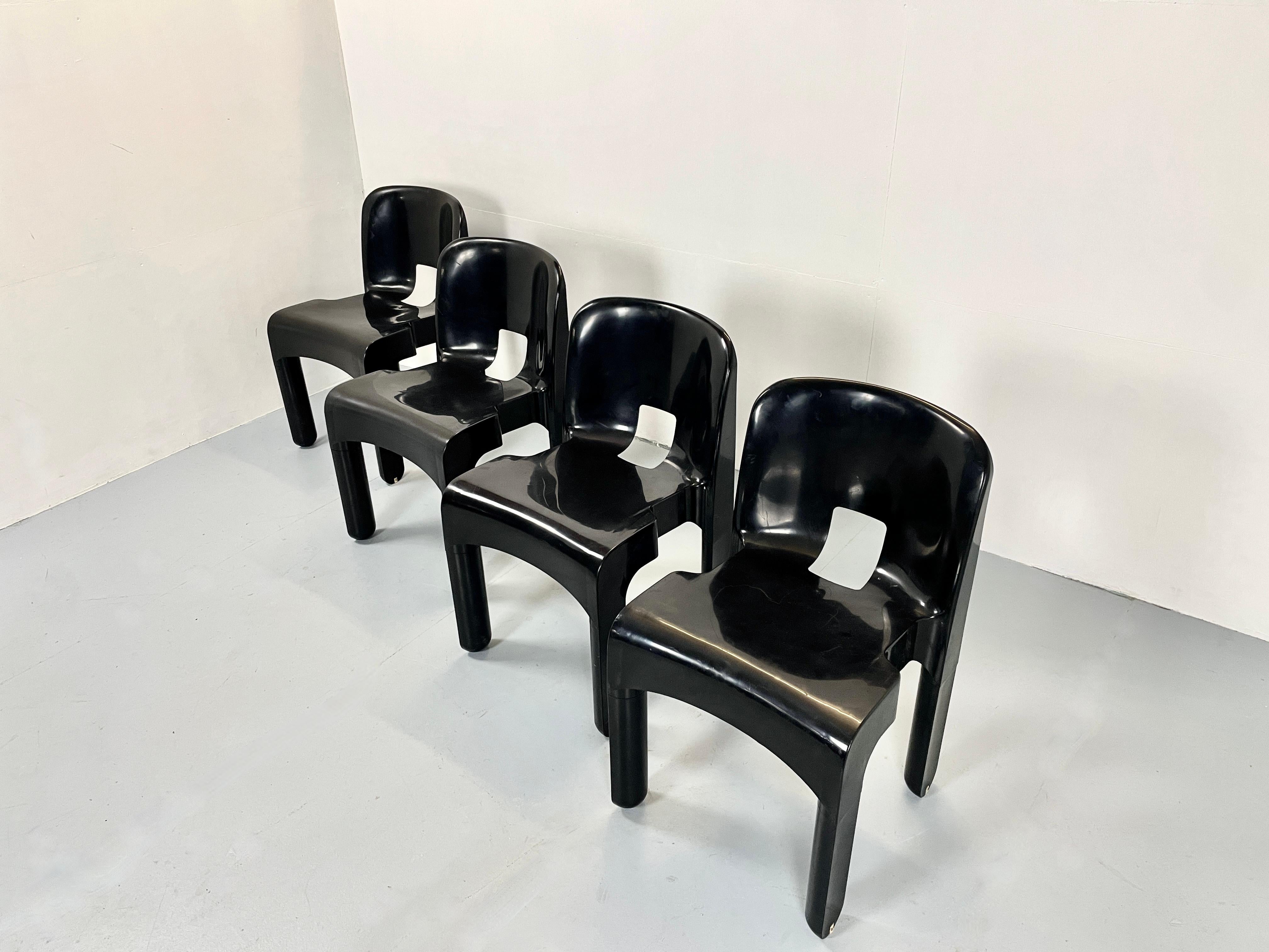 Nice set of eight Italian chairs by Joe Colombo.

The black plastic model 4867 universale chair are a true Italian icon.
Manufactured and stamped by Kartelle Italy.

The Universale chair is one of the first molded plastic chairs created.