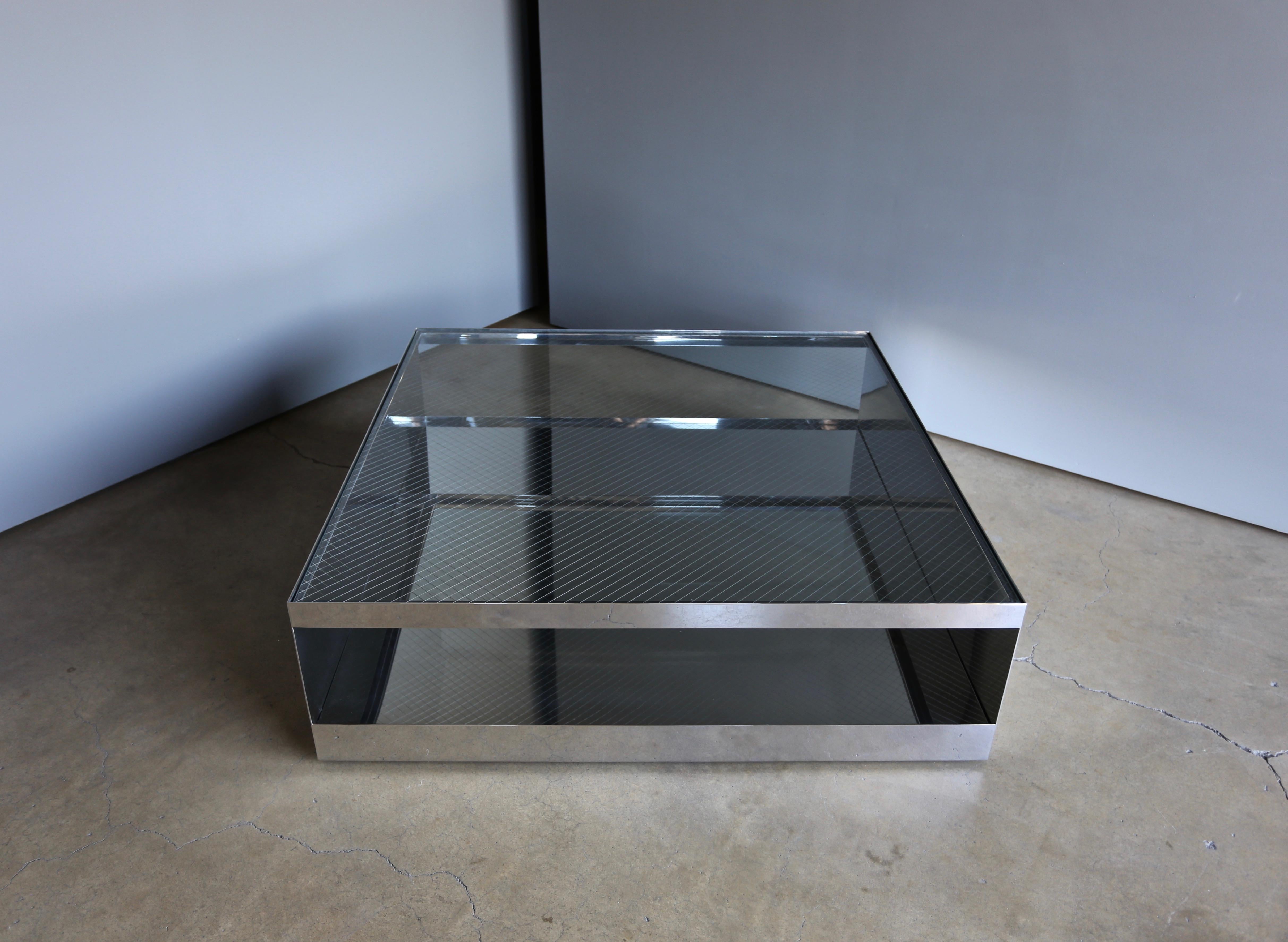 Joe D'urso polished stainless steel & safety glass coffee table for Knoll, circa 1981. 

This piece has been professionally polished. The table rolls on hidden castors.