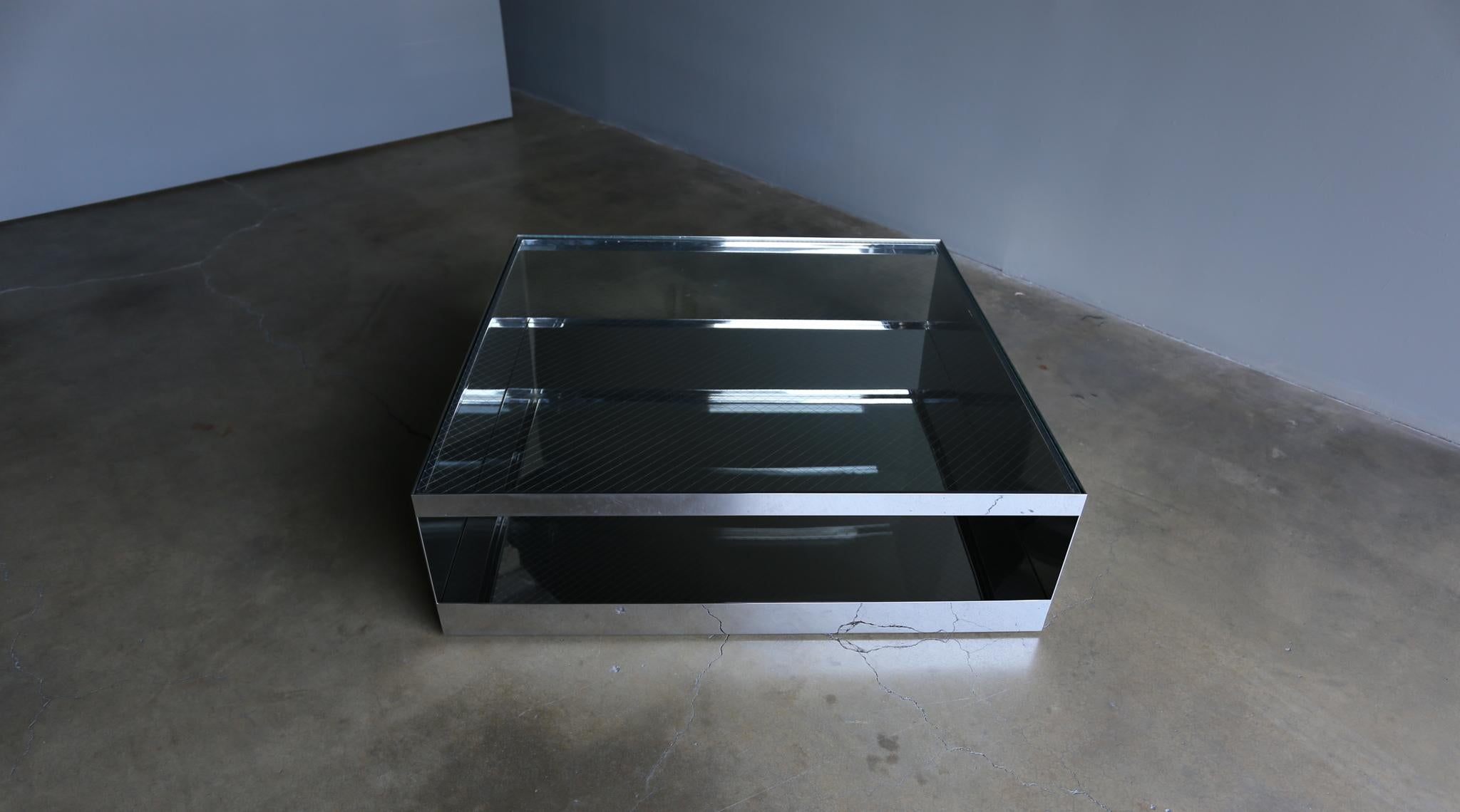 Joe D'urso polished stainless steel & safety glass coffee table for Knoll, circa 1981.

This piece has been professionally polished. The table rolls on hidden castors.