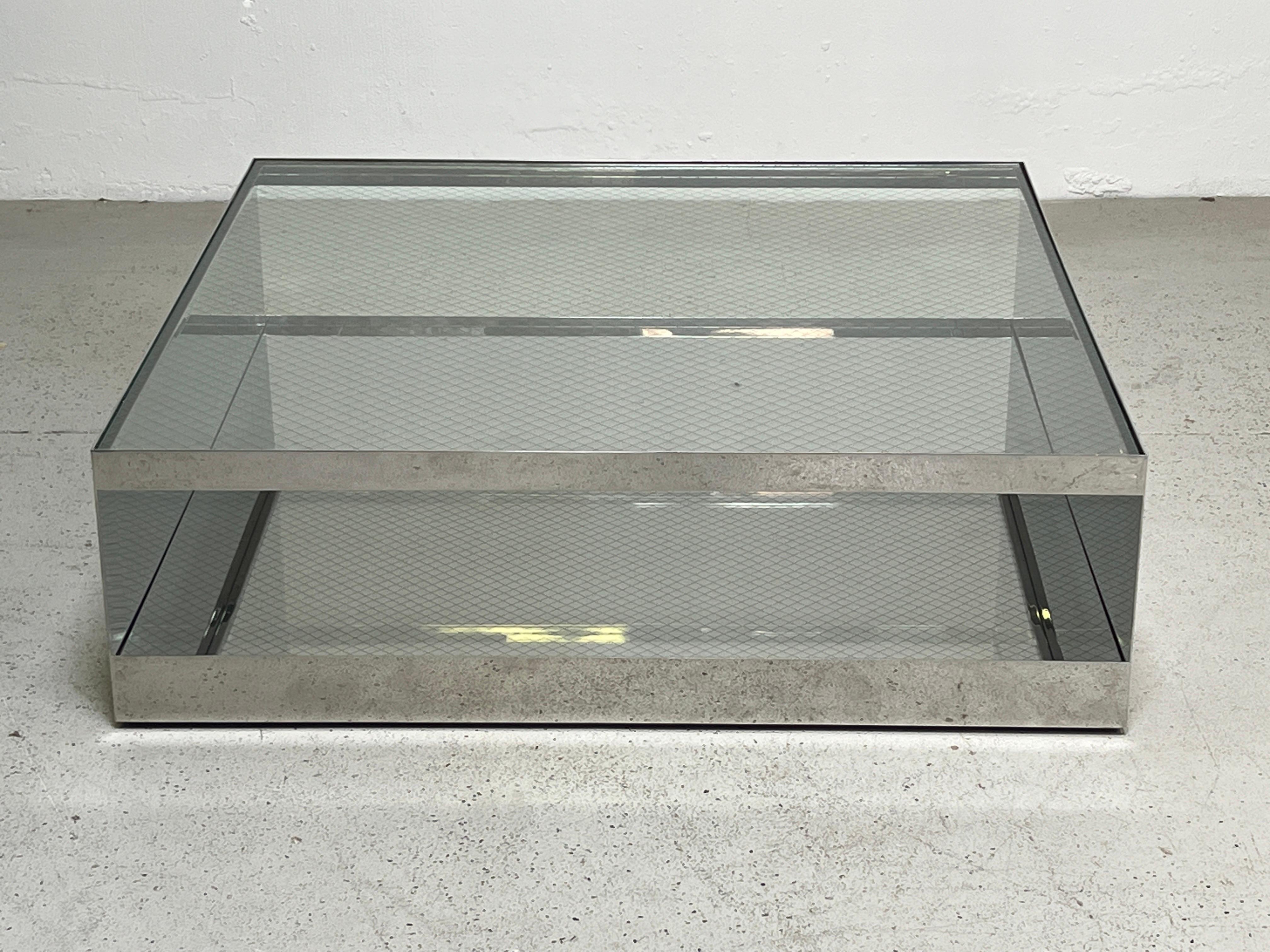 A polished stainless steel table with safety glass top. Designed by Joe Durso for Knoll.