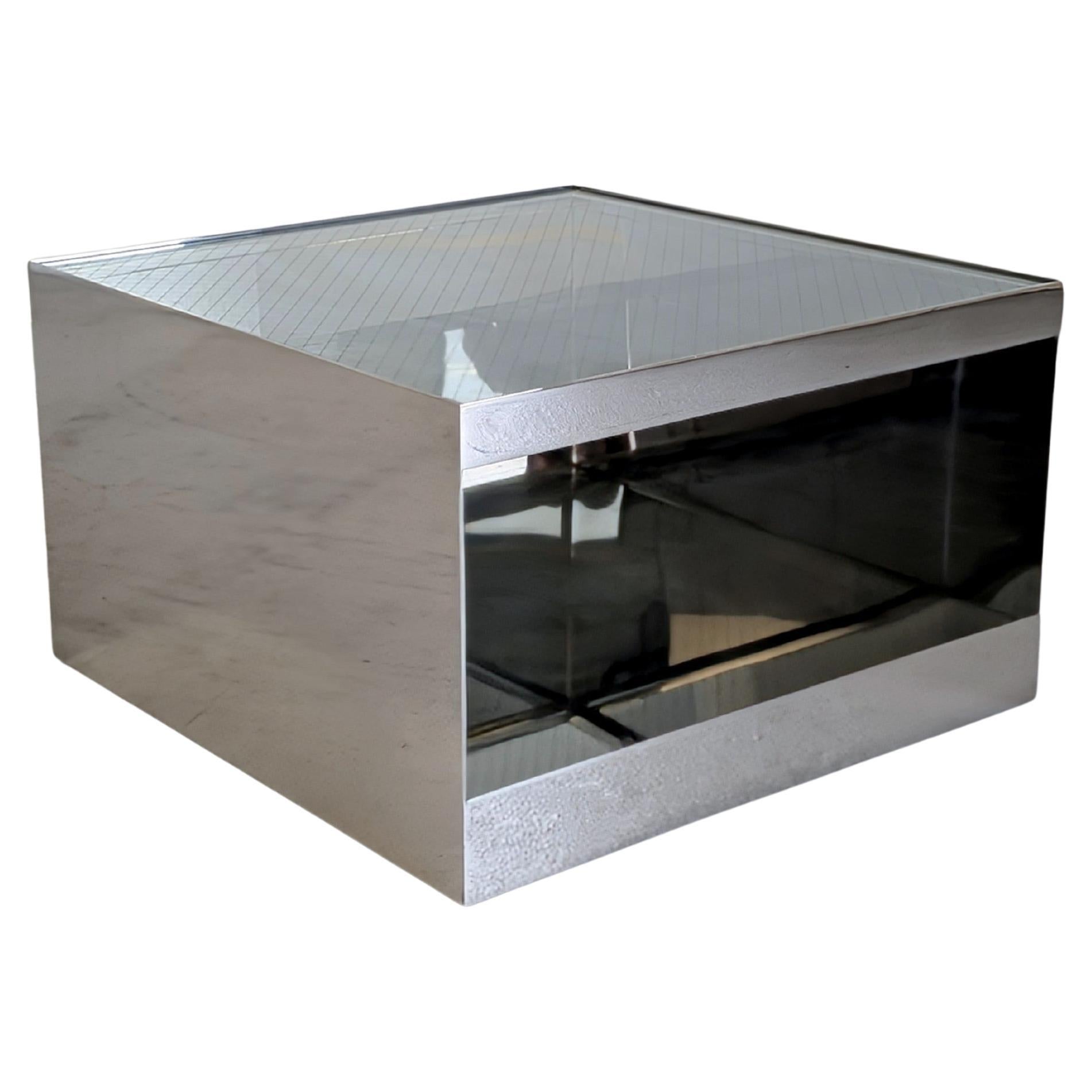 Joe D'Urso designed Polished Stainless Steel End Table for Knoll circa 1980s. Cataloged as Model 6027T.  Clean and modern designed functional two tiered table that features a safety wire glass top. Table also has hidden casters for easier placement