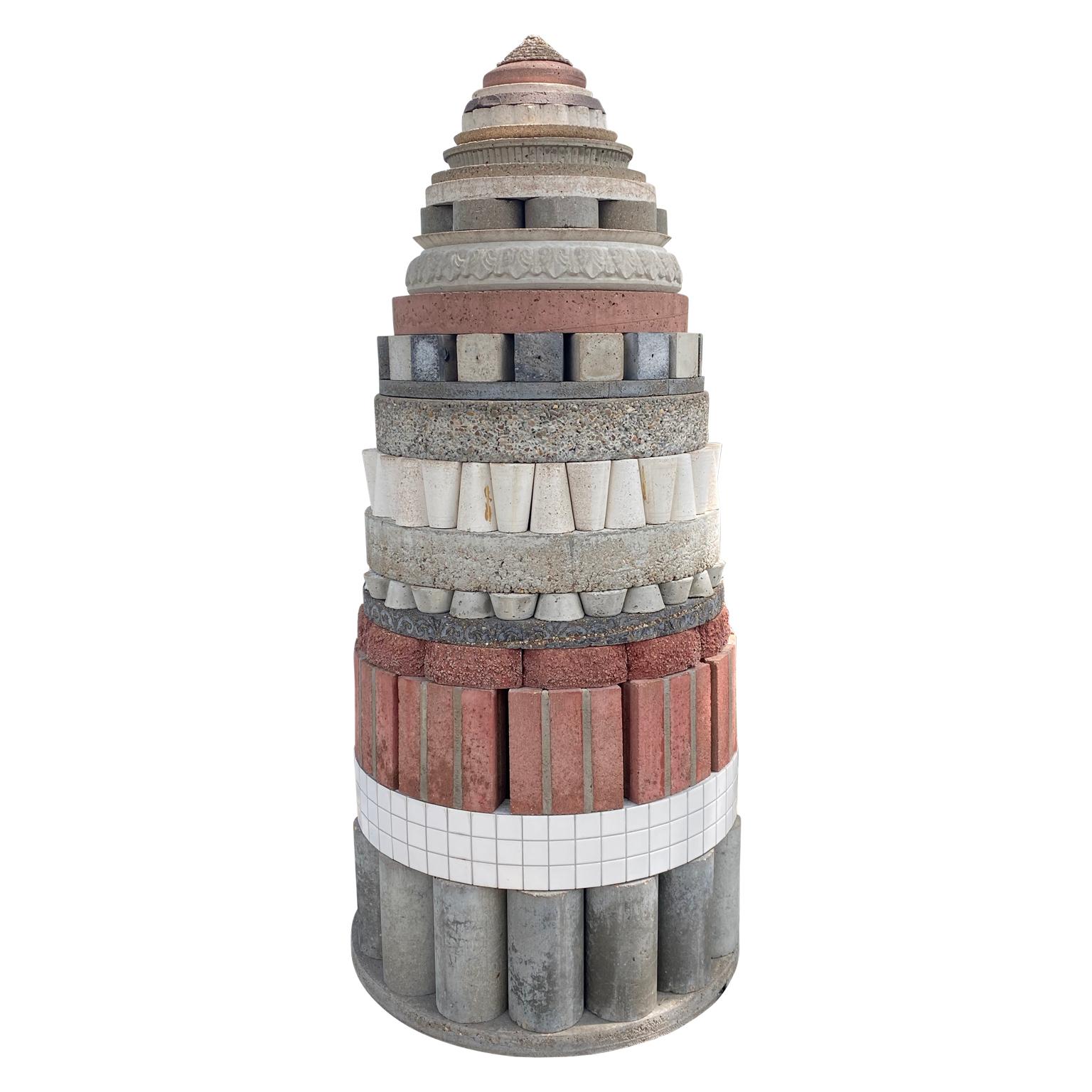 Modern abstract outdoor totem sculpture by Houston artist Joe Mancuso. The piece is constructed out of various decorative brick, stone, and concrete pieces all stacked into a tapered tower. The work is able to be displayed both indoors or outdoors.