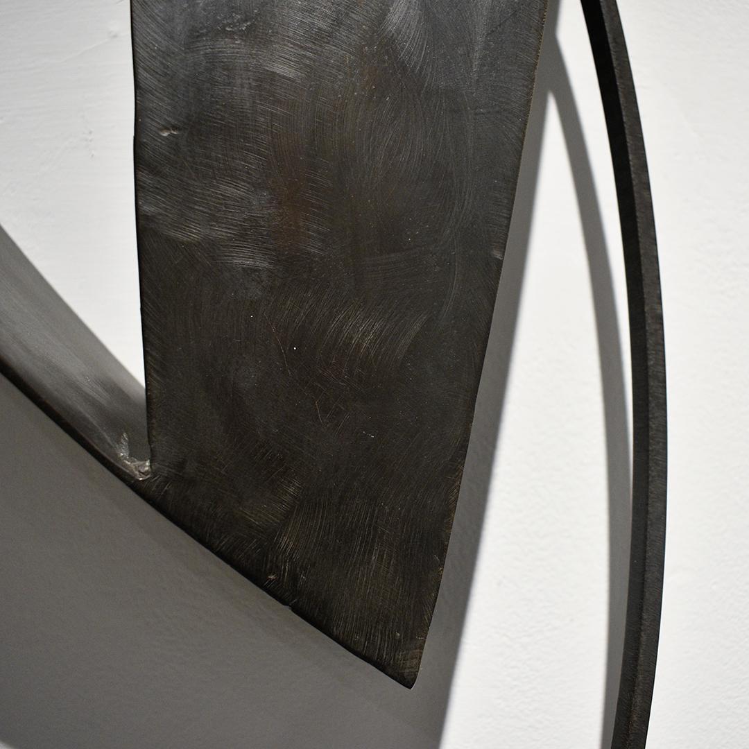 Minimalist, abstract three dimensional wall sculpture in dark oxidized metal
Temptation Was an Ally, made by Joe Wheaton in 2019
42 x 16 x 7 inches, oxidized brass
Hangs of a French cleat, sculpture is lightweight (about 5lbs.)
Signed, verso

Joe
