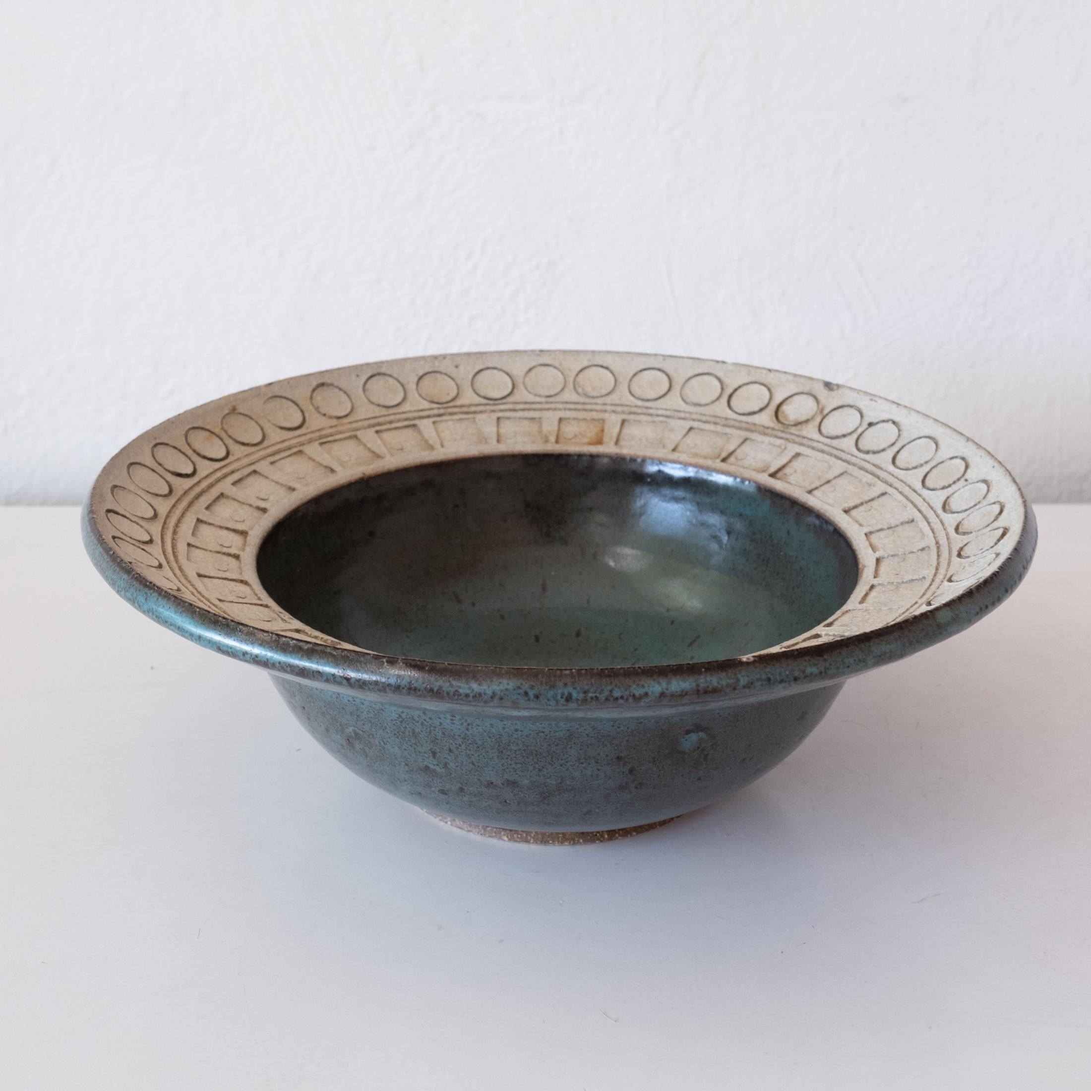 Stoneware bowl with incised geometric decoration by California artist, Joel Edwards. 1960s

Joel Edwards. Los Angeles, CA. Studied at Otis Art Institute under Peter Voulkos. Creator of “Creative Crafts” Magazine, 1960-1964.

6.5 inches wide x 3