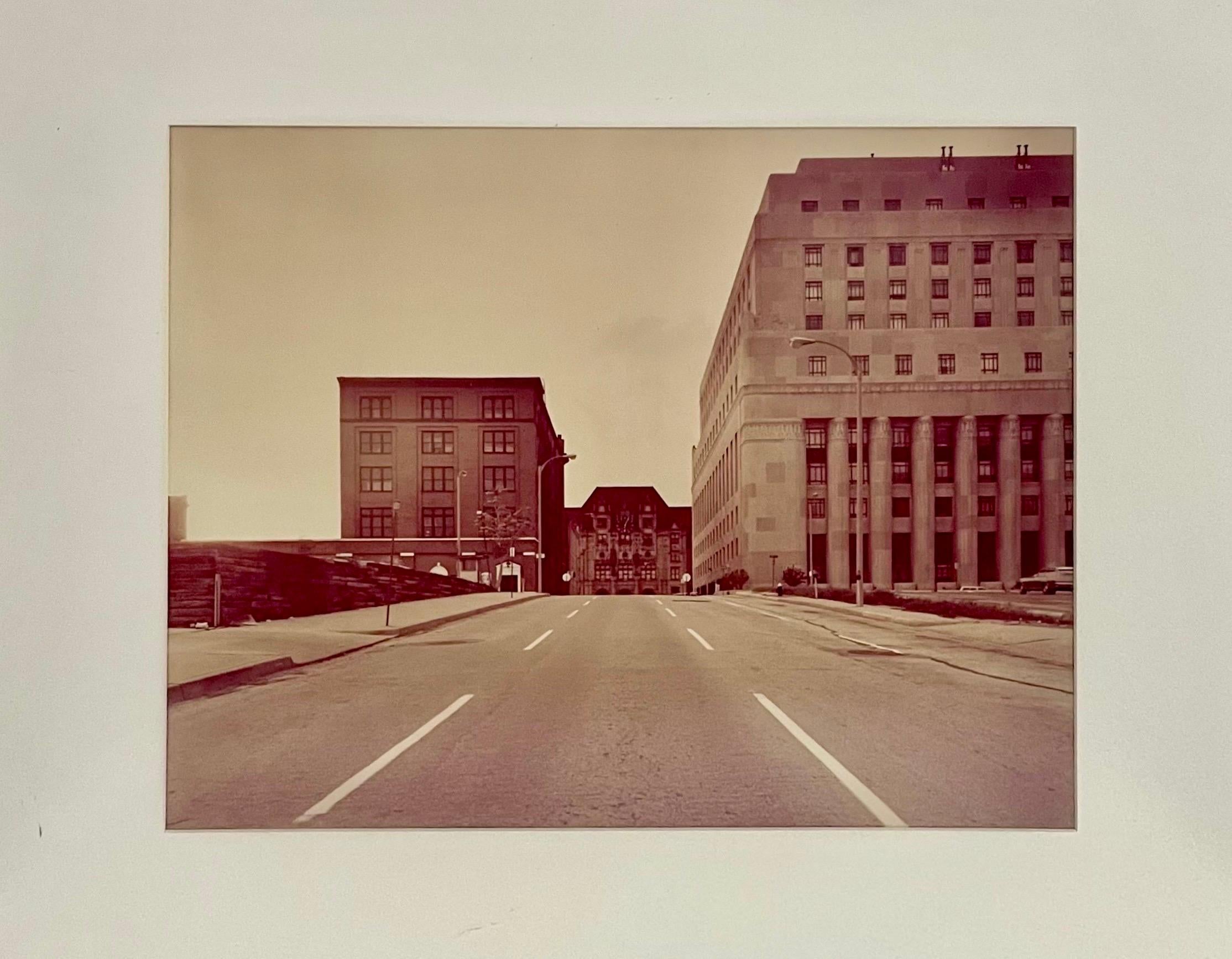 St. Louis and the Arch Vintage Photograph
St. Louis: title, signature, dated 1977, copyright 1982, and edition 1/10 to verso. 
View down Walnut St. of St. Louis' city hall building.
Images: 15 x 19 in. (16 X 20), frames: 22 1/2 x 28 1/2