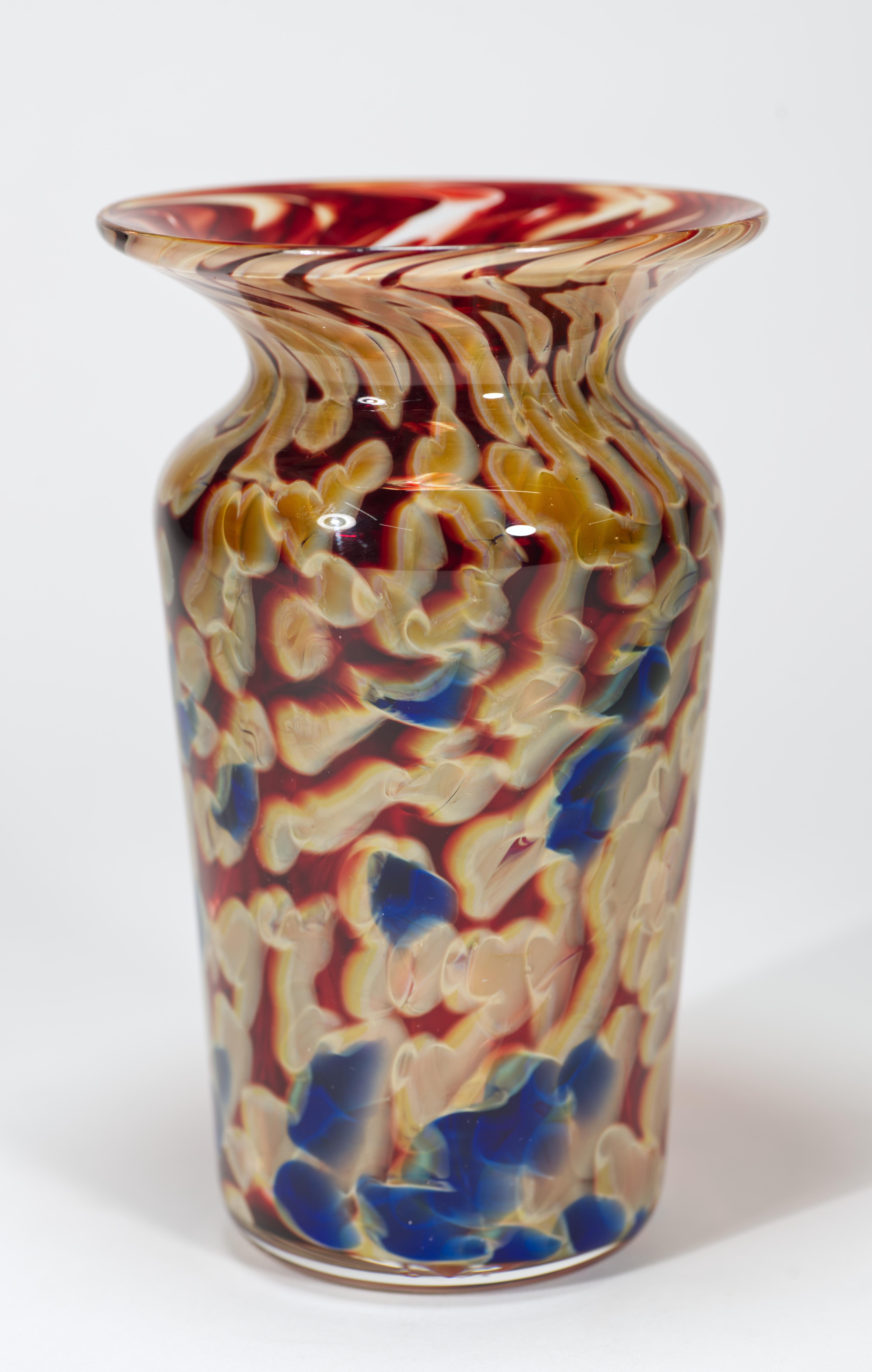  Fused glass vase features complex multilayered colored glass core in dark Bordeau or burgundy red, cream, and sapphire blue colors, encased in clear glass in sommerso technique. Complex layering of colored glass elements adds another layer of