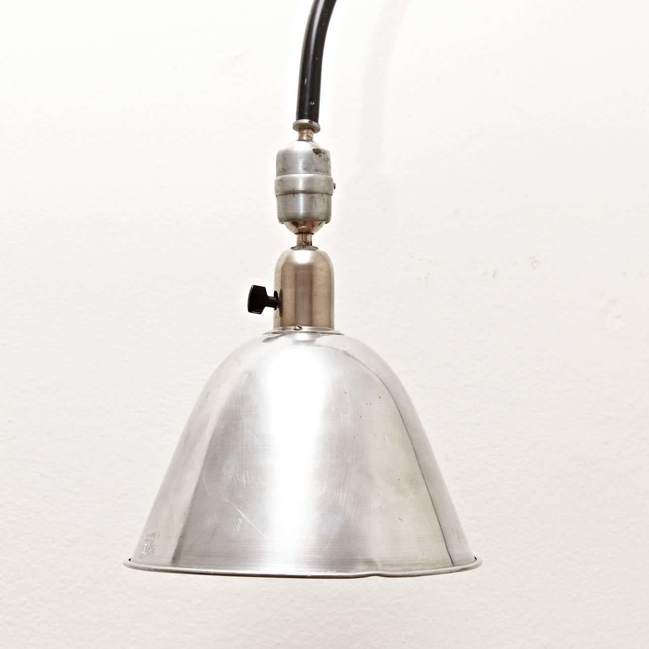 Wall lamp designed by Johan Petter Johansson.
Manufactured by Triplex (Sweden), circa 1930.
Aluminium and steel.

In good original condition with minor wear consistent with age and use, preserving a beautiful patina.