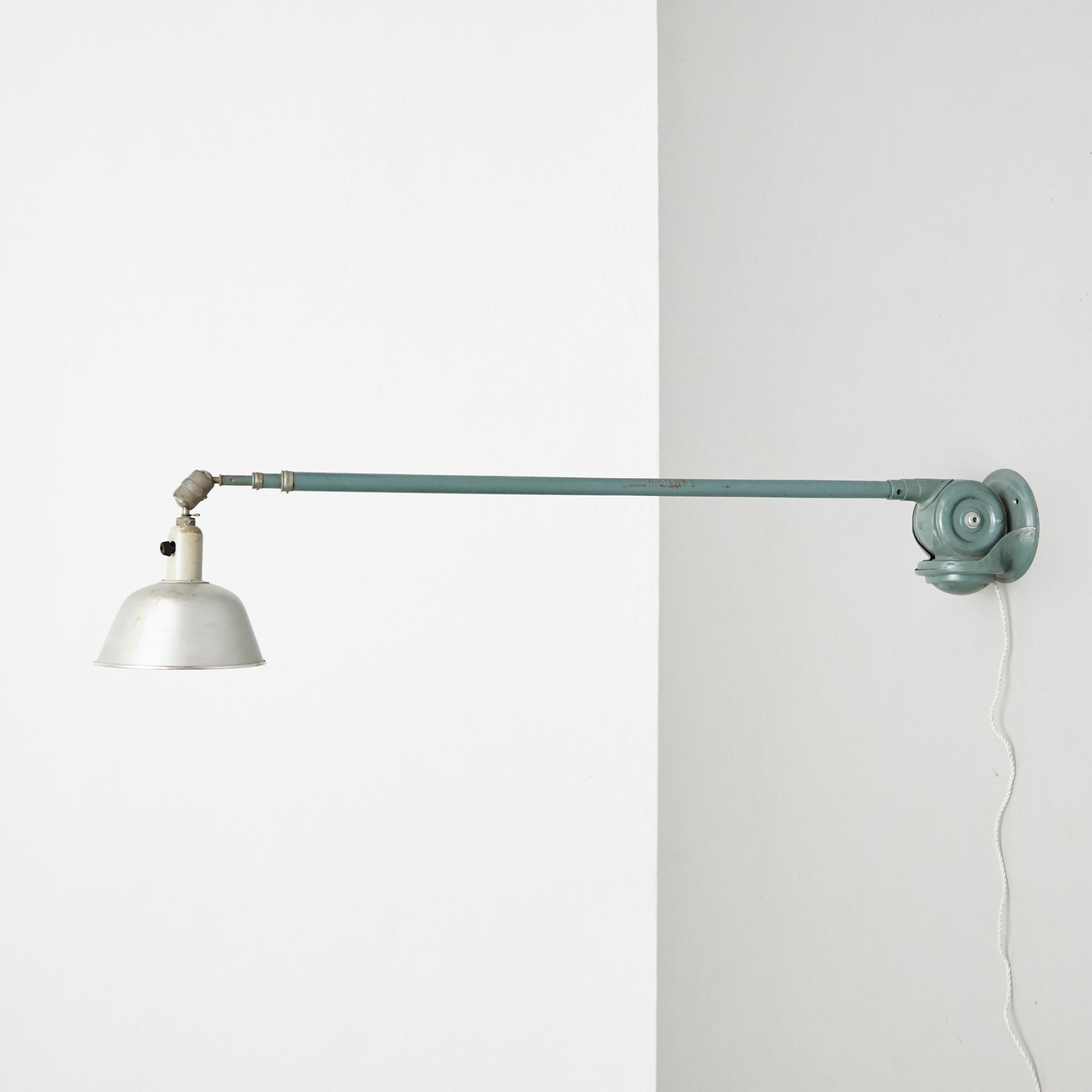 Wall lamp designed by Johan Petter Johansson.
Manufactured by Triplex (Sweden), circa 1930.
In original condition, with minor wear consistent with age and use, preserving a beautiful patina.

Materials:
Aluminium 
Steel

Dimensions:
ø 23 cm