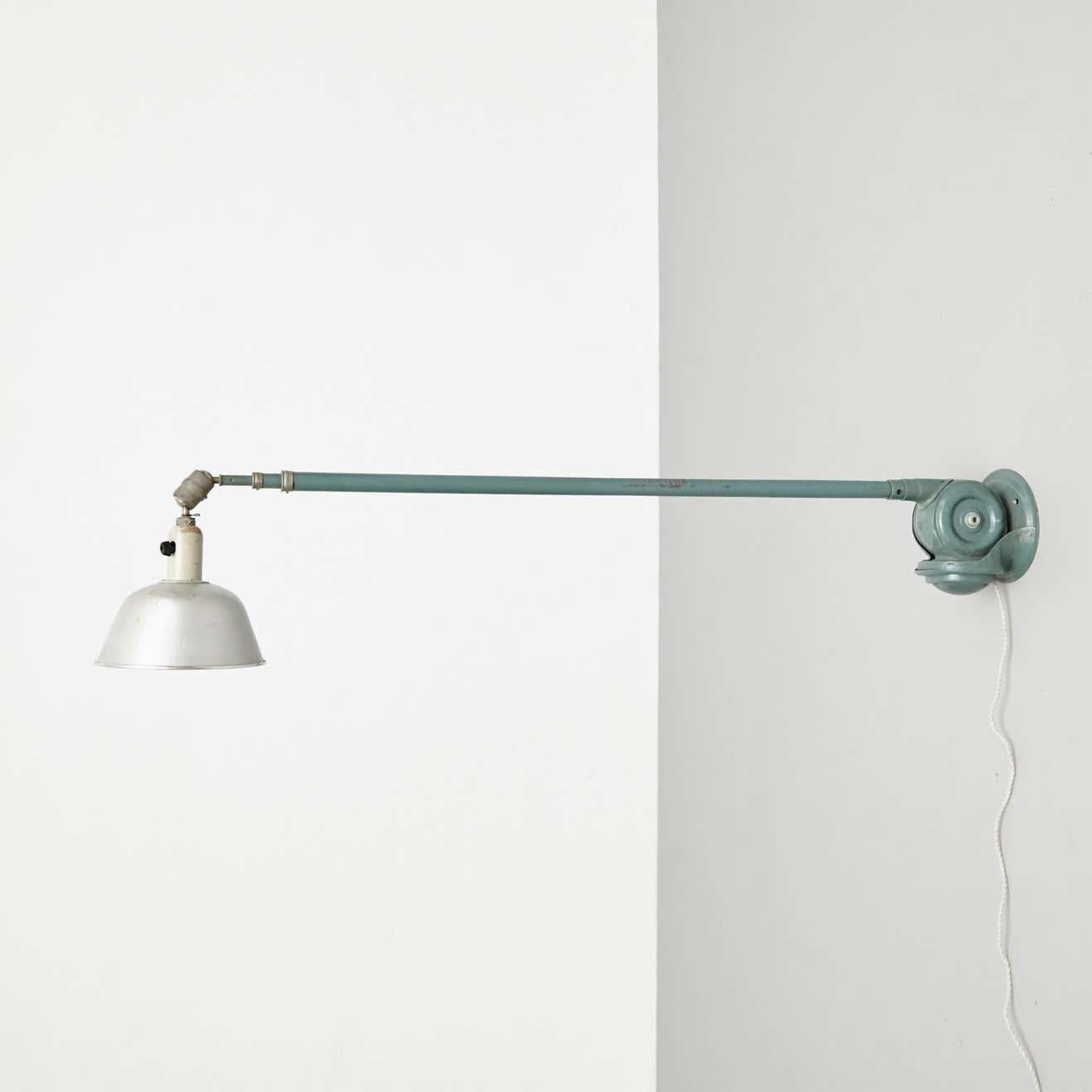 Wall lamp designed by Johan Petter Johansson.
Manufactured by Triplex (Sweden), circa 1930.
In original condition, with minor wear consistent with age and use, preserving a beautiful patina.

Materials:
Aluminum 
Steel

Dimensions:
ø 23 cm