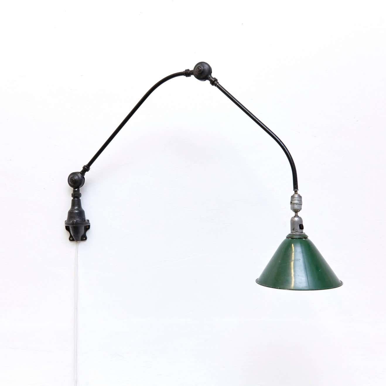 Wall lamp designed by Johan Petter Johansson.
Manufactured by Triplex (Sweden), circa 1930.
Aluminium and steel.

Measures: Height 94 x width 123 cm, 26.5 diameter

In good original condition, with minor wear consistent with age and use,