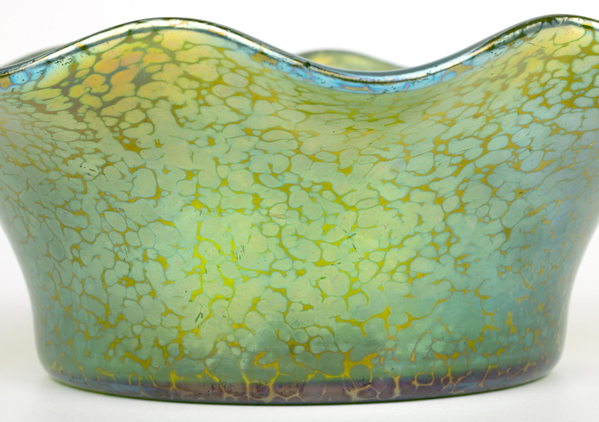 A stunning large Art Nouveau green Papillon iridescent art glass bowl by Johann Loetz Witwe in Klostermühle in southwestern Bohemia and dating from around 1900. The large Loetz bowl is of wide rounded form standing on a flat base with polished