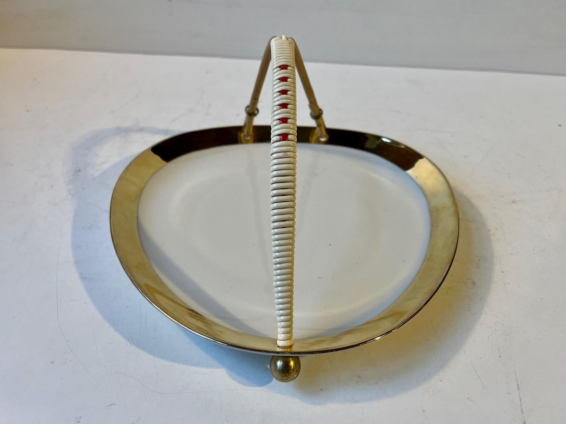A rare configuration of af JSV chocolate, cake or cookie dish. Decorated with gold-glaze, brass-ball and bamboo handles with plastic rattan. Made by Johann Seltmann Vohenstrauss circa 1950-1960 in Germany. Measurements: 20x20x11 cm.
