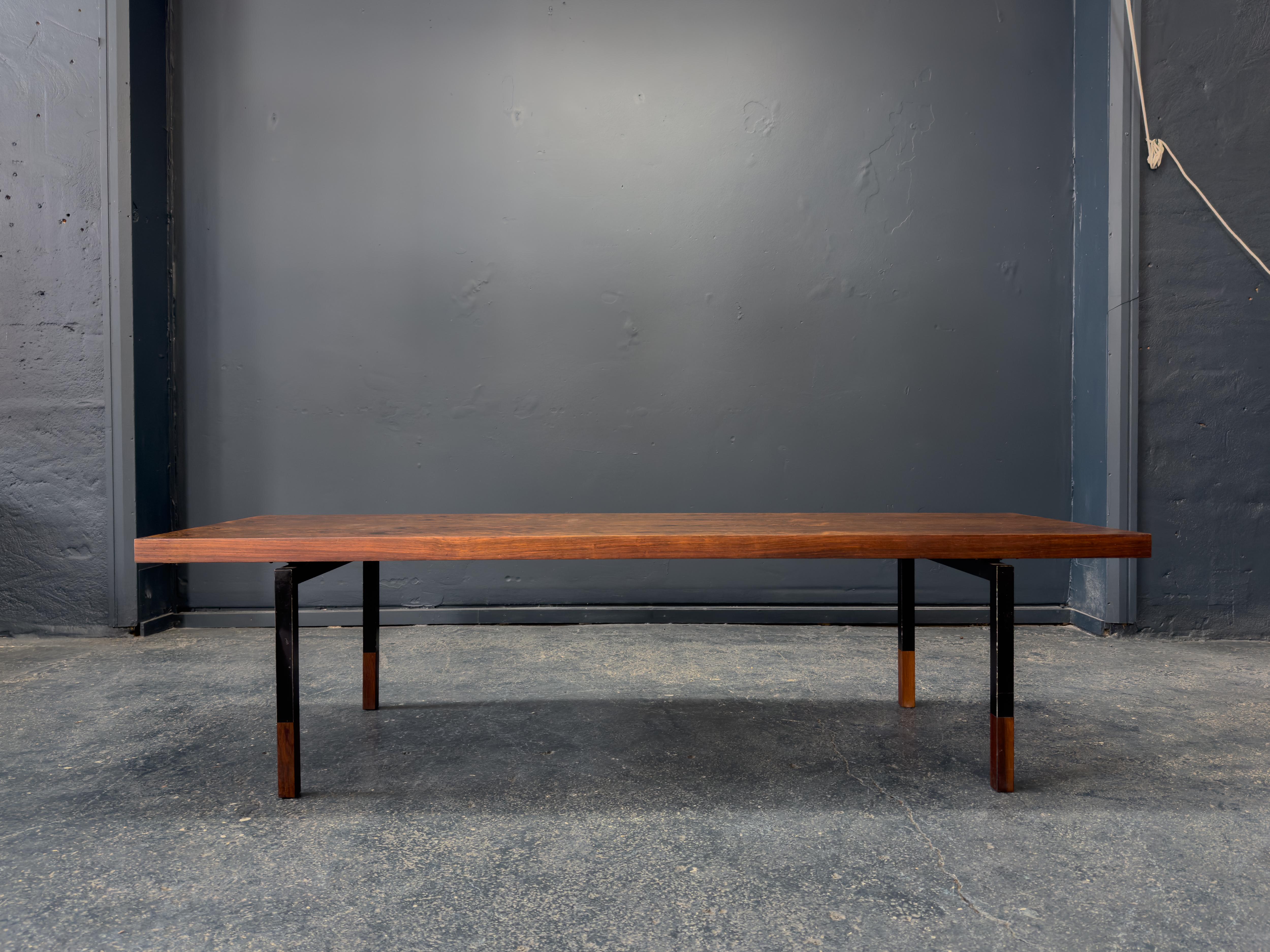 This large coffee table by Johannes Aasbjerg is a striking example of Danish modernism at its most refined and confident. With commanding proportions and exceptional craftsmanship, the table showcases a richly figured wood top—its dramatic grain