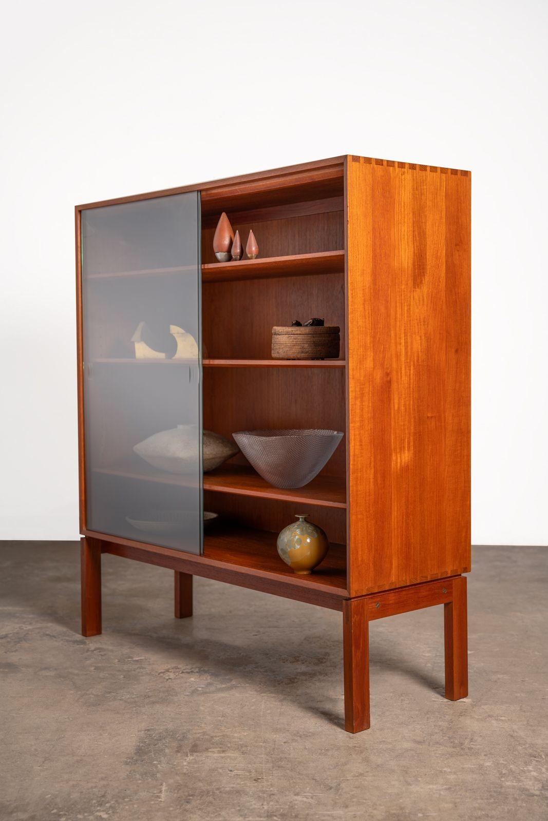 A rare Johannes Aasbjerg vitrine imported from Denmark in the 1960s. This is a deep display case so it will accommodate larger ceramic bowls and sculptures that smaller bookcases will not. Extraordinarily well crafted of solid teak. The doors are