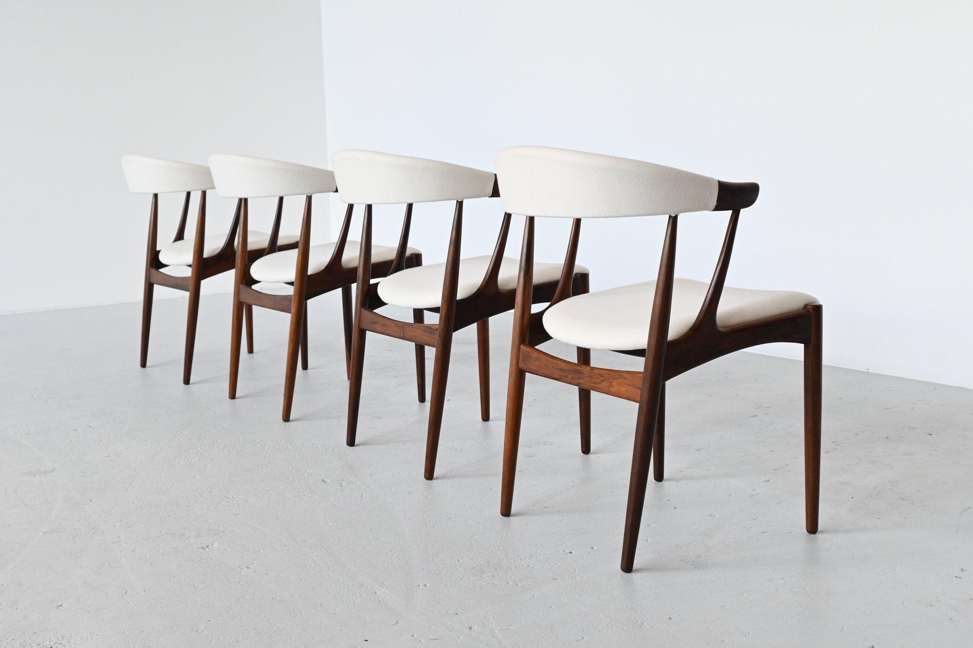 Stunning set of dining chairs model BA113 designed by Johannes Andersen and manufactured by Brdr. Andersens Møbelfabrik A/S, Denmark 1969. The chairs features a solid rosewood frame and they are newly upholstered with white Divina upholstery from