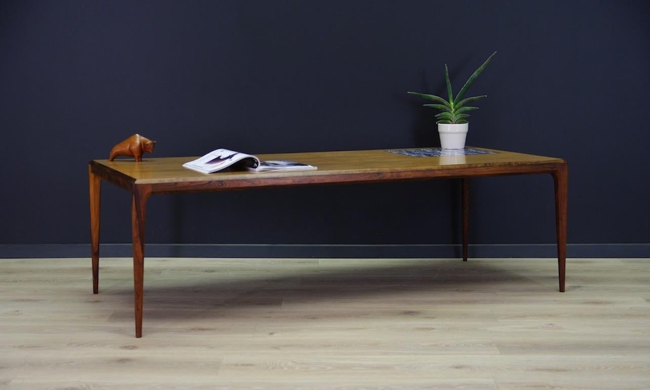 Classic 1960s-1970s coffee table, Scandinavian design, Minimalist form designed by leading Danish designer Johannes Andersen for C.F.C. Silkeborg. Finished with rosewood veneer. There is a tile insert on the countertop. Preserved in good condition