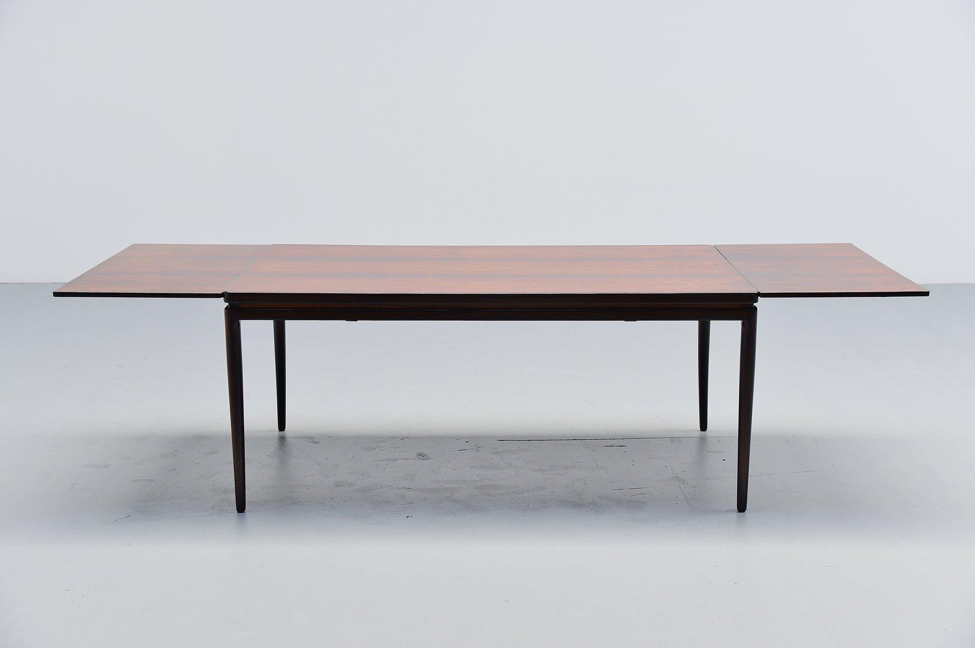 Nice Danish modern rosewood extendable dining table designed by Johannes Andersen for Christian Linneberg, Denmark 1964. This table has an amazing grain to the warm rosewood veneer. In normal position this table is 165 cm long, when you extract the