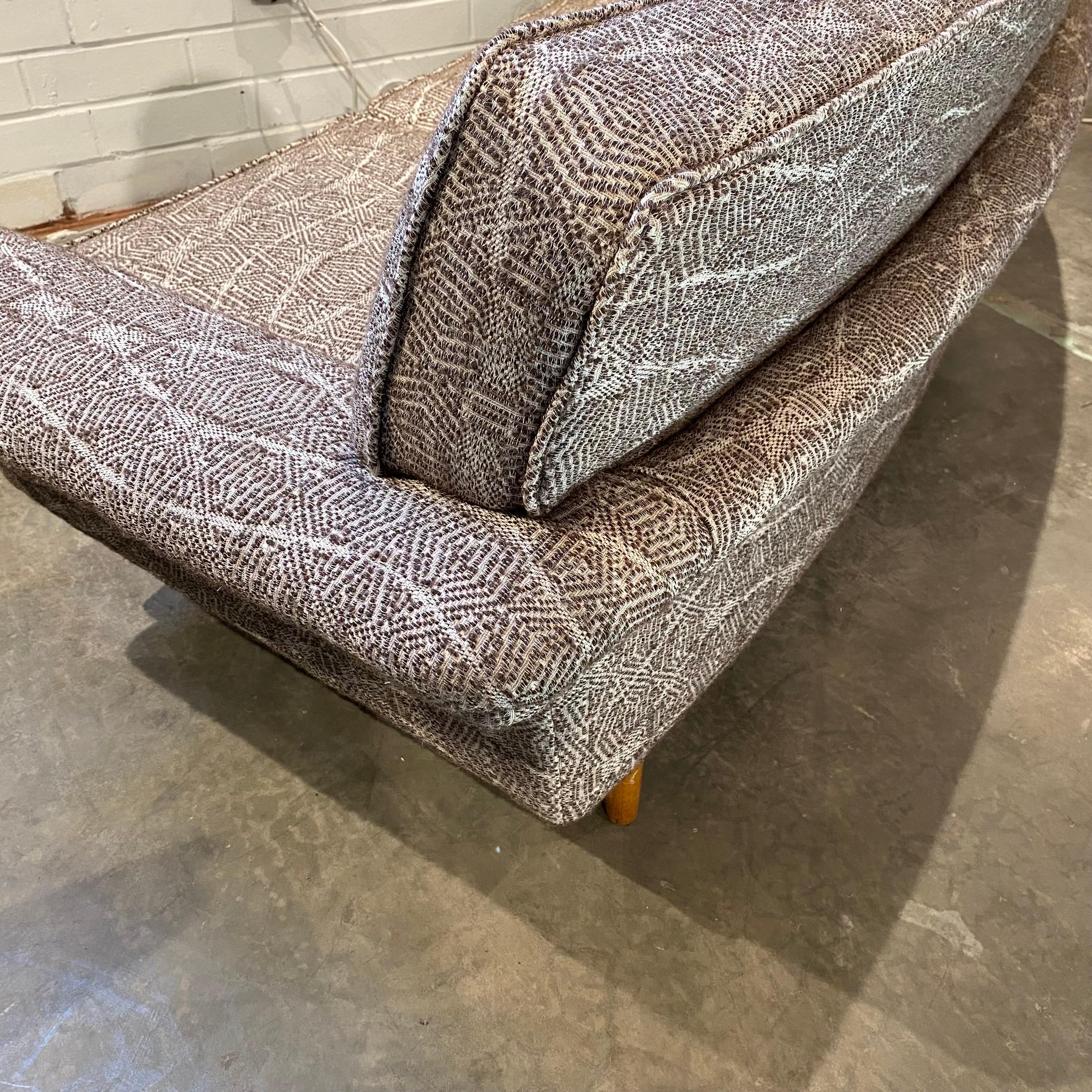 A stunning design updated with textured abstract upholstery.  Clearly a unique sofa with simple curved form and great lines.