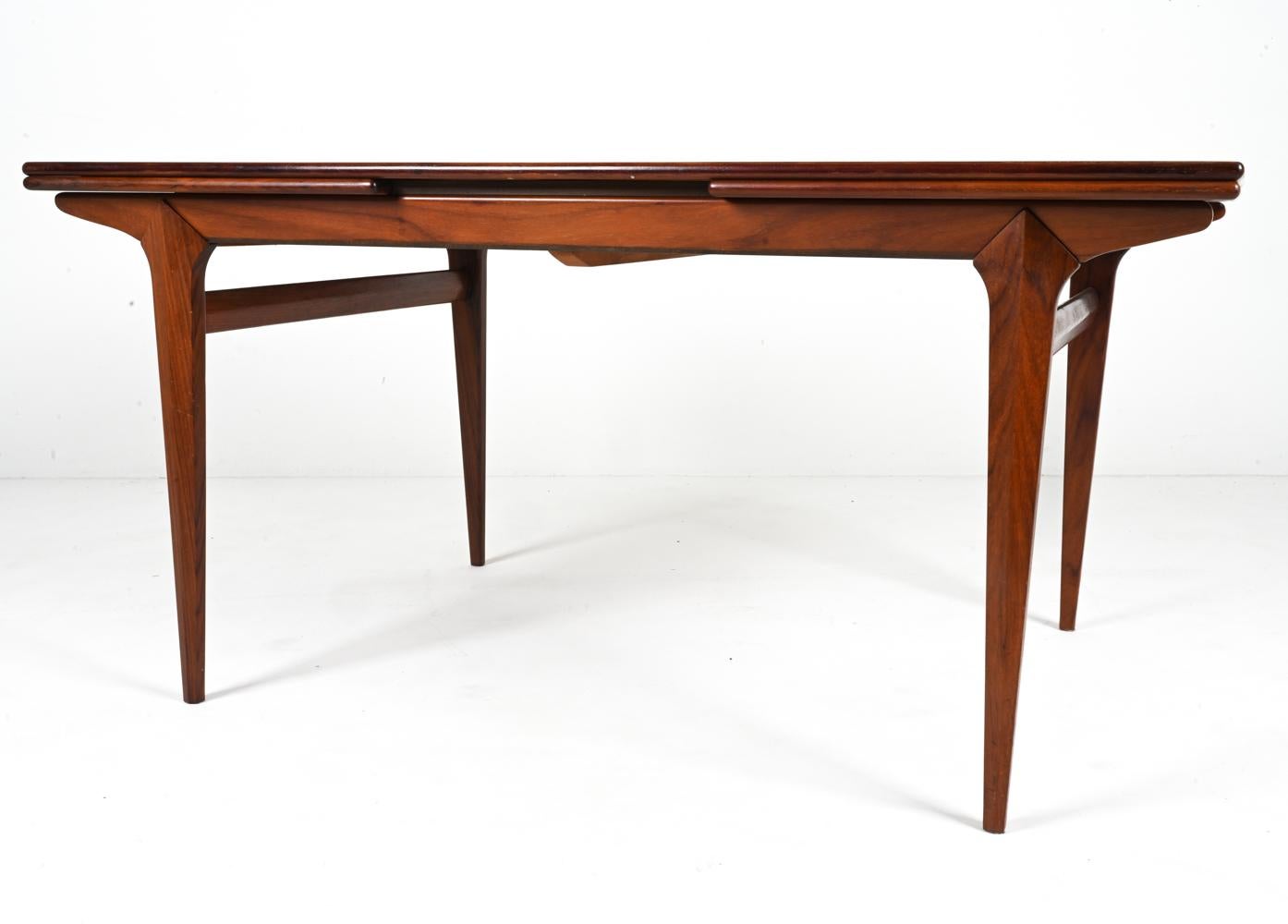 The Johannes Andersen Extension Table in Mahogany epitomizes the sophisticated fusion of craftsmanship and design innovation. Crafted by the Danish designer Johannes Andersen, this dining table showcases the timeless elegance and functionality