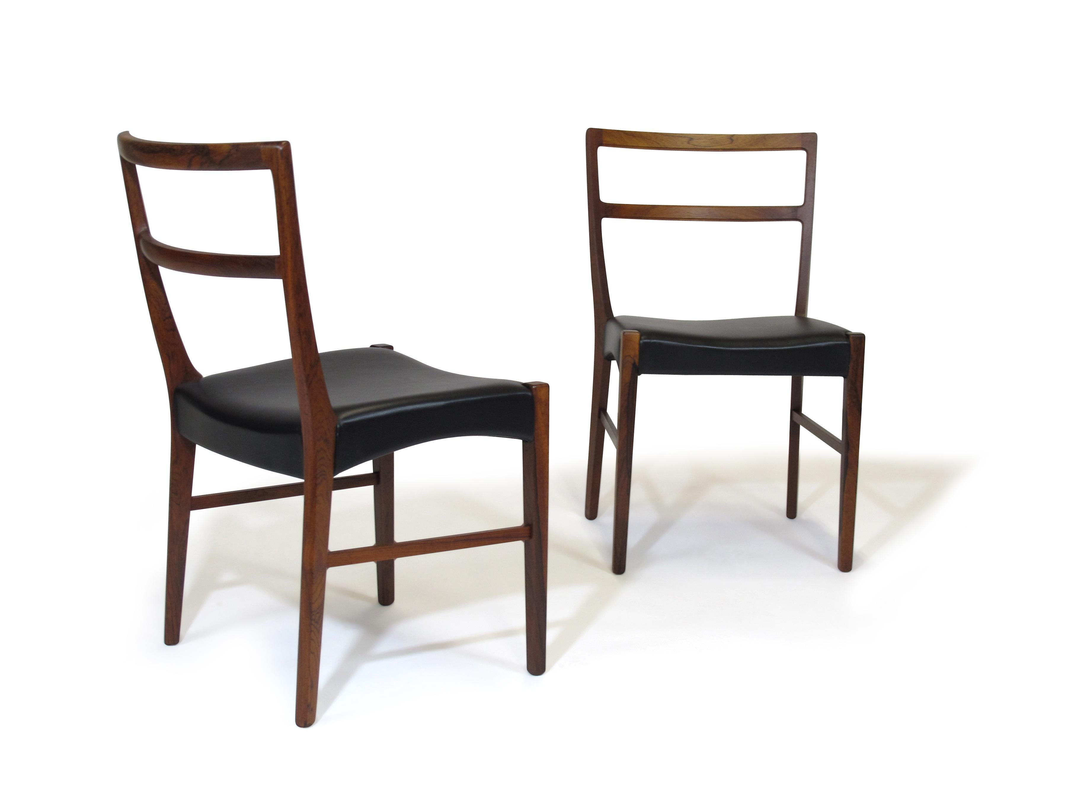 Minimal and classic form dining chairs designed by Johannes Andersen, handcrafted by Bernhard Pedersen Sons, Denmark in 1965. The elegant set of eight chairs feature solid Brazilian rosewood frames; lightly restored preserving original patina and