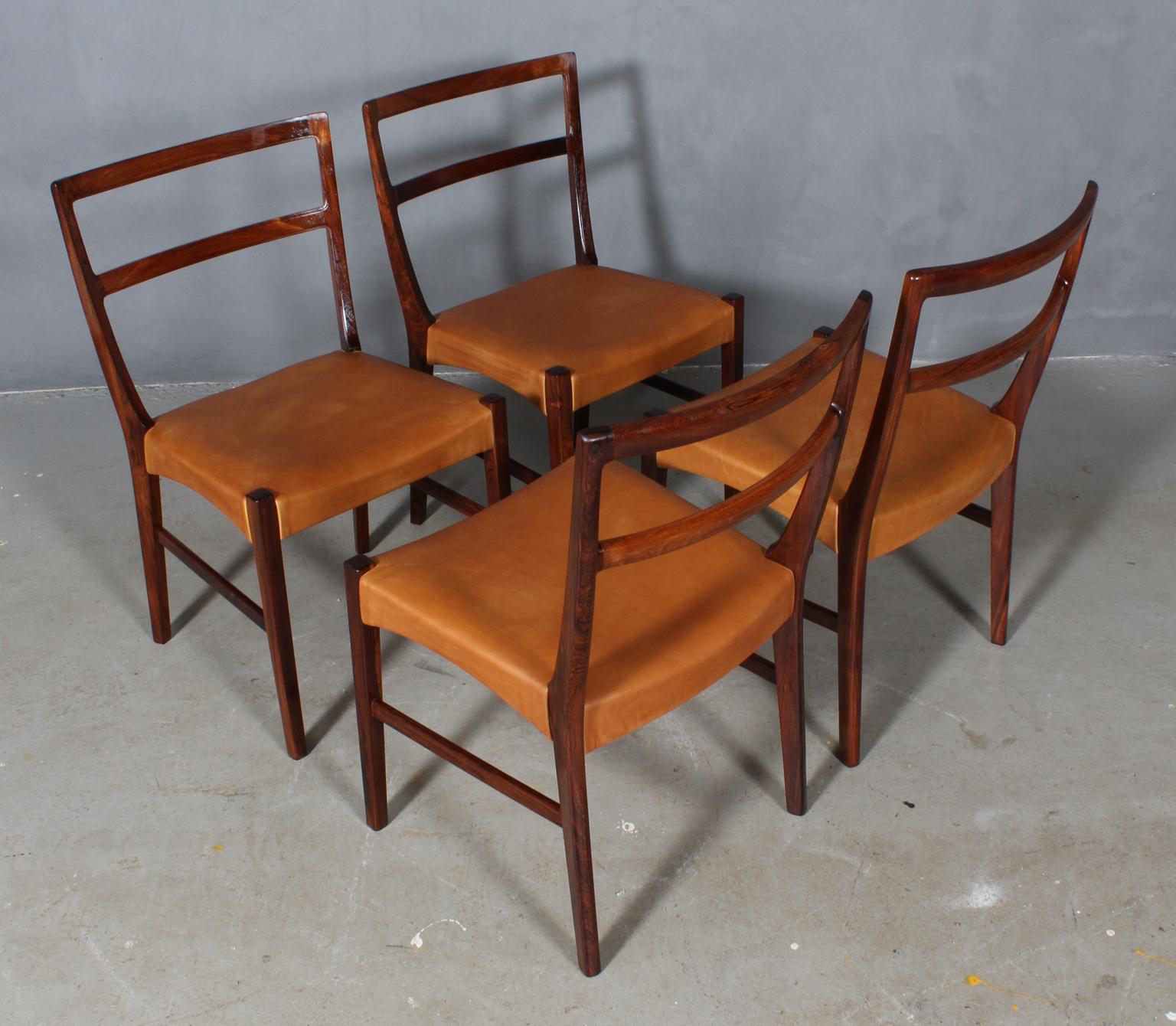 Johannes Andersen four dining chairs in solid oiled rosewood.

New upholstered with vintage tan aniline leather.

Made by Bernhard Pedersen & Søn.