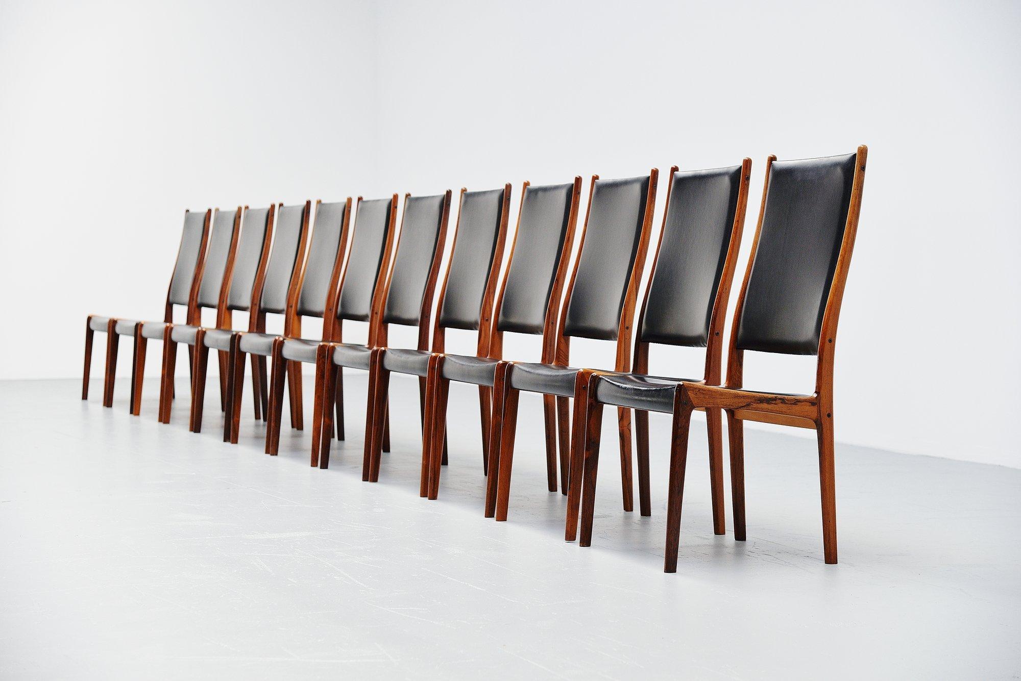 Very nice and large set of high back dining chairs designed by Johannes Andersen and manufactured by Uldum Mobelfabrik, Denmark 1960. The chairs have solid rosewood frames and black vynil seats and back. The chairs seat very comfortable with the