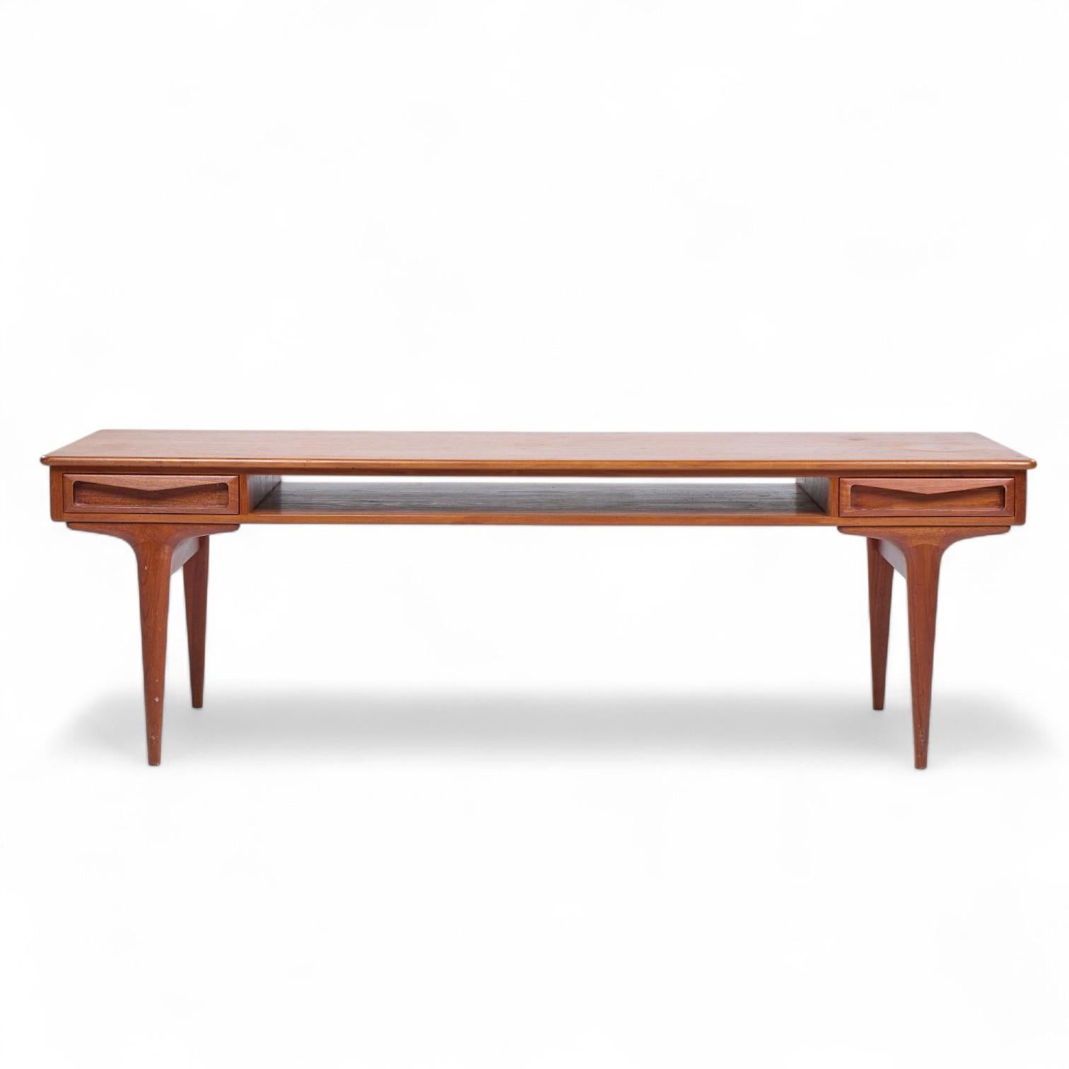 Johannes Andersen Mid Century Danish Teak Coffee Table

This coffee table measures: 63 wide x 21.25 deep x 20 inches high

All pieces of furniture can be had in what we call restored vintage condition. That means the piece is restored upon purchase