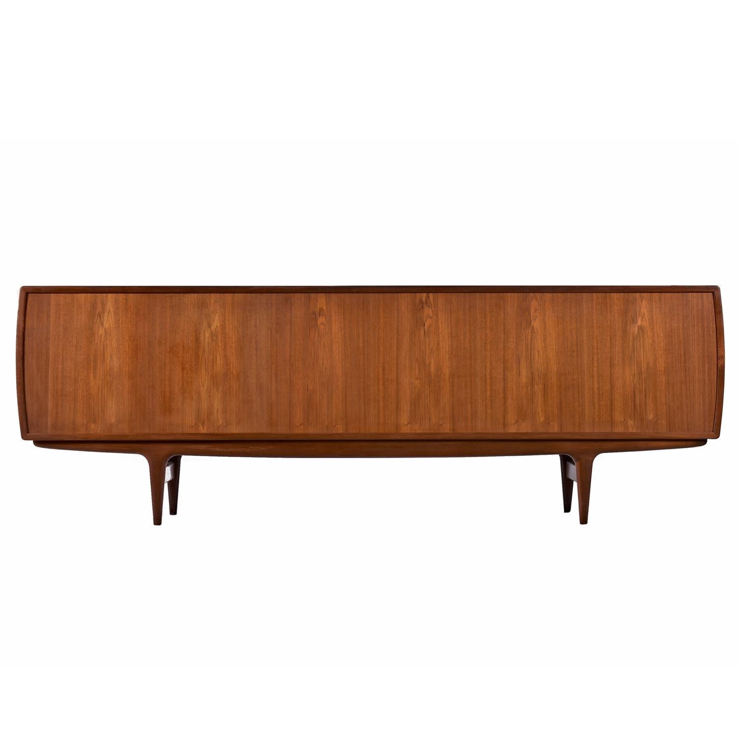 Johannes Andersen for Uldum Møbelfabrik Model-19 credenza restored to excellent condition. This stunning mid-century sideboard is a mix of solid teak and teak veneer over hardwood. Captivating from every direction and completely finished on the back