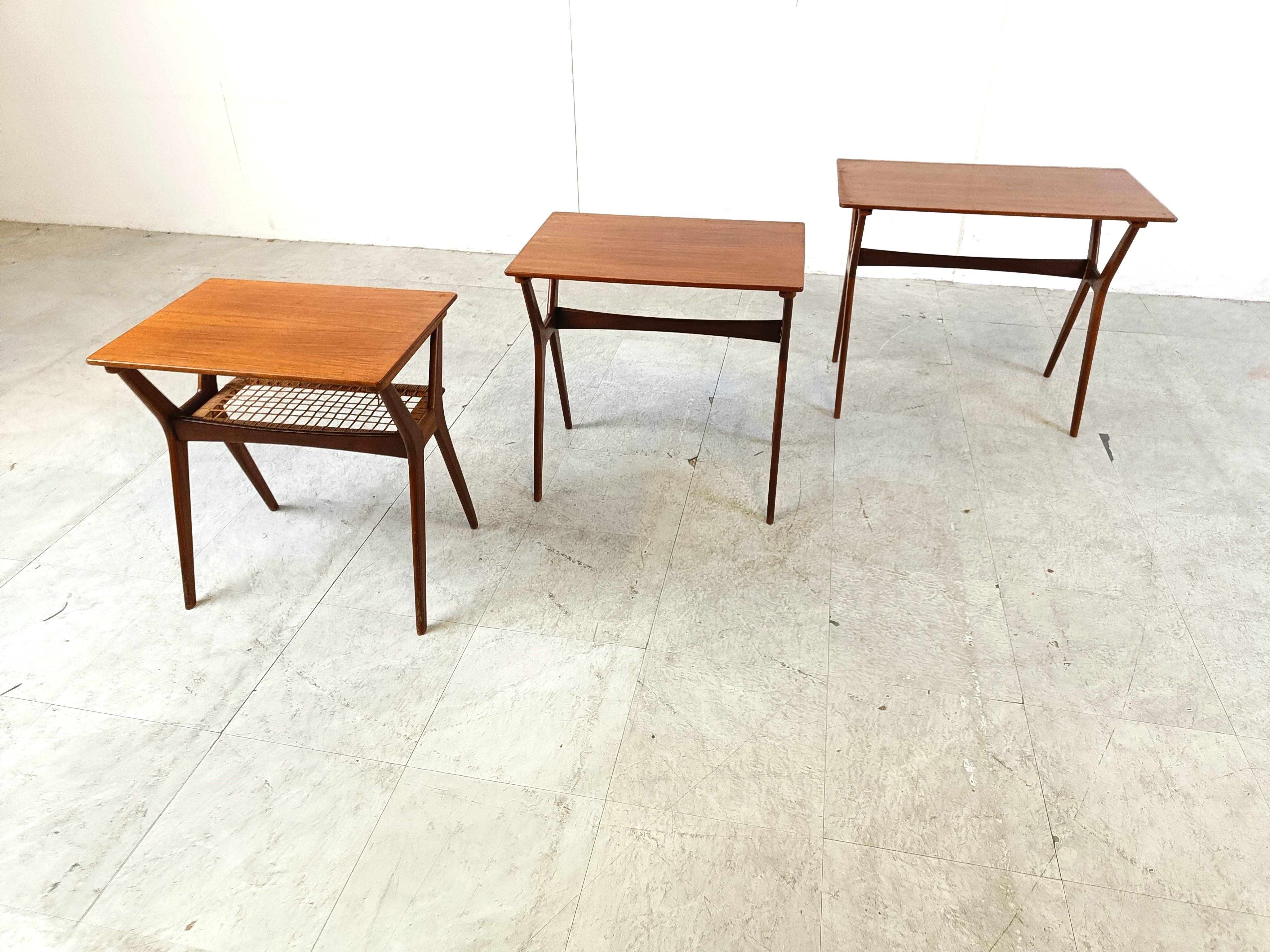 Mid century teak nesting tables by Johannes Andersen for Silkeborg Mobelfabrik.

The tables perfectly slide into each other forming a beautiful nest of tables.

The lowest table has a cane webbing lower tier.

Very good condition

1960s -