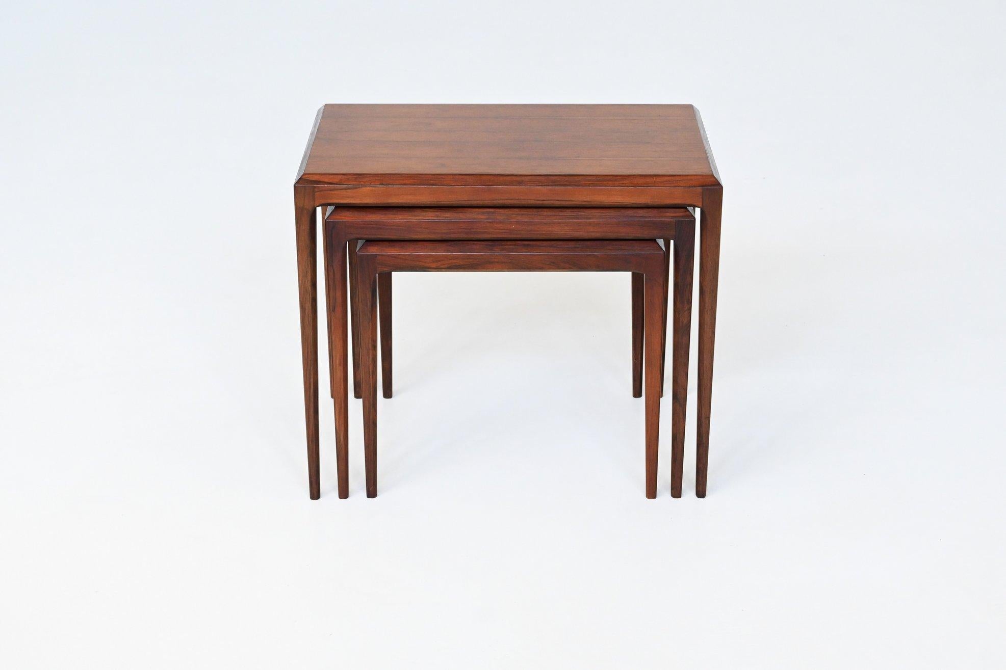 Beautiful shaped set of three nesting tables model 163 designed by renowned Danish designer Johannes Andersen for CFC Silkeborg, Denmark 1960. This sophisticated set of nesting tables is made of high-quality rosewood. They display a beautifully rich