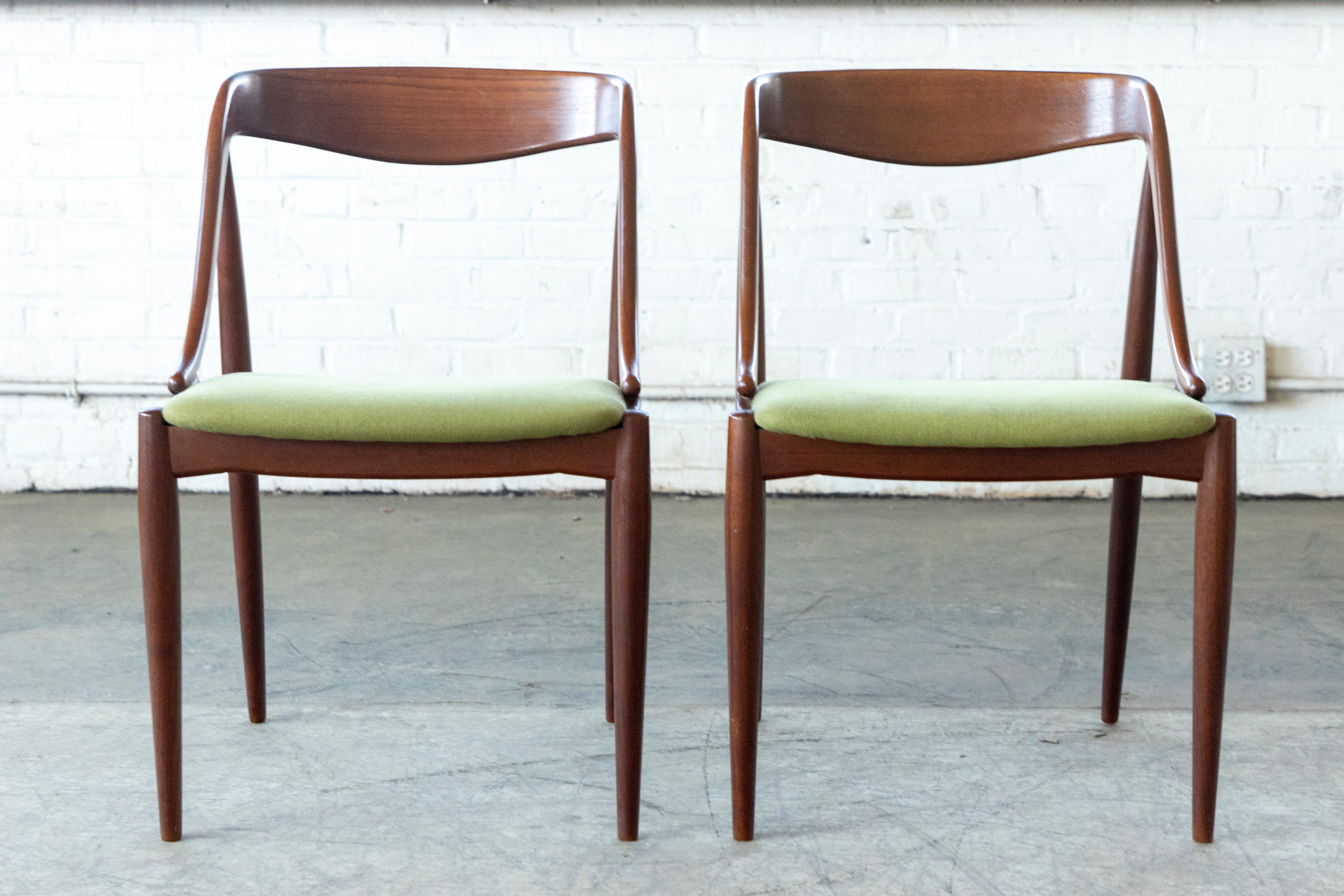 Fantastic pair of of armchairs or desk chairs designed by Johs. Andersen in the 1950's for Uldum in Denmark. Rare model sought after and perfect accent chairs or desk chairs for any modern home. Made of solid teak. We are able to re-upholster at a