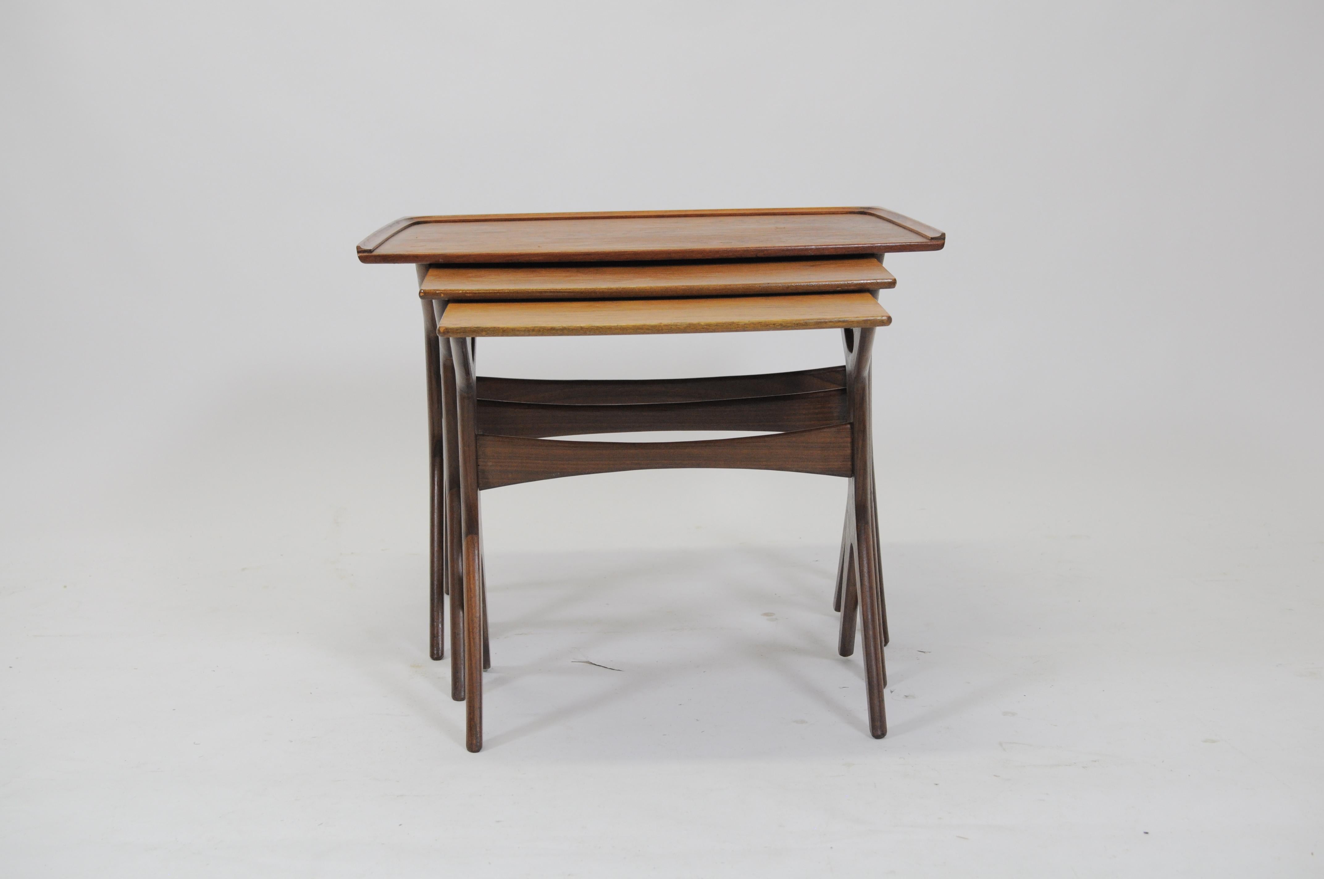 Johannes Andersen refinished set of Danish teak nesting tables by CFC Silkeborg.

The nesting tables have been checked, restored and refinished by our cabinetmaker to ensure that they are in in very good condition with only small and minimal signs