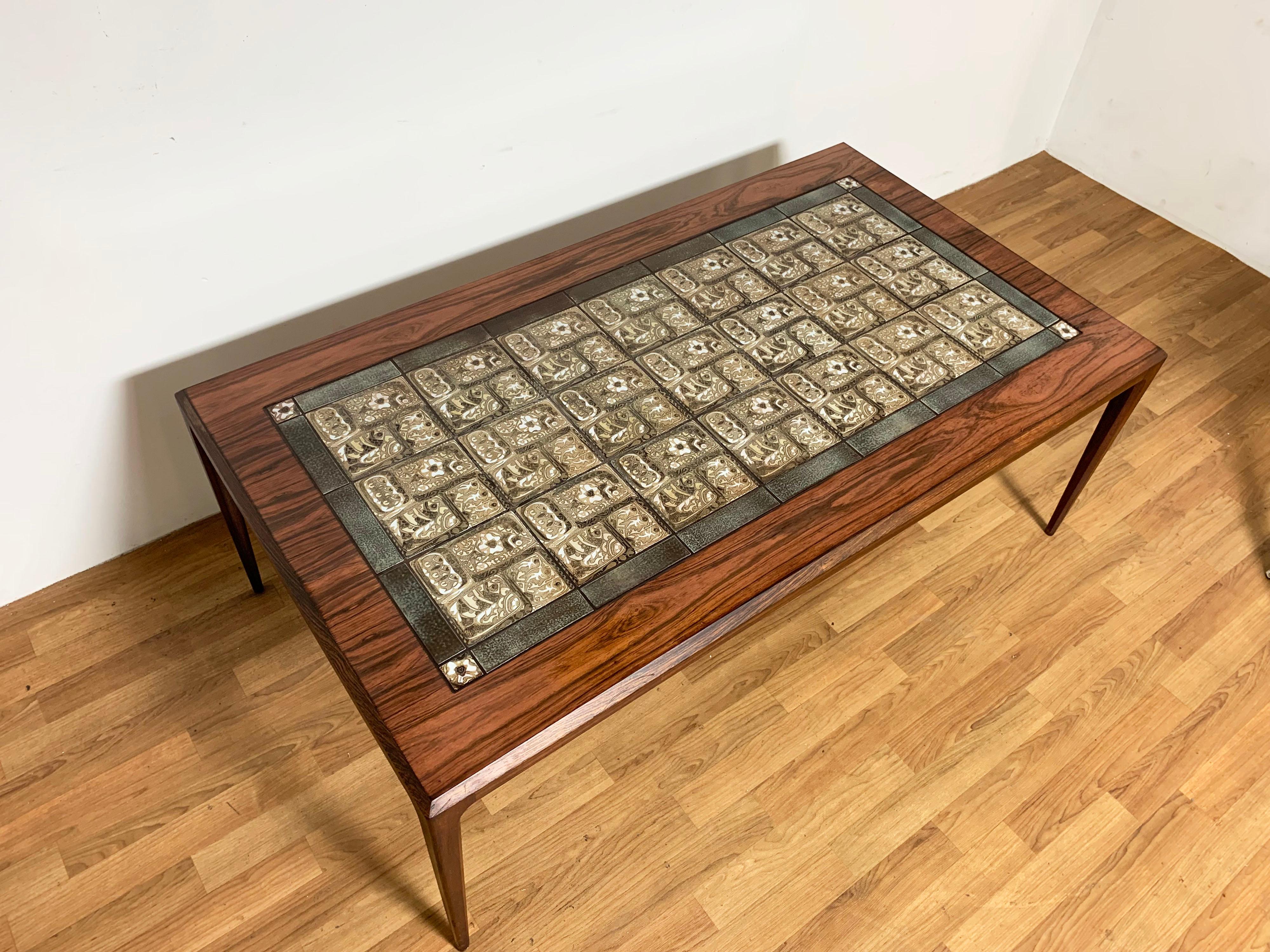 Danish rosewood coffee table designed by Johannes Andersen for C. F. Christensen, featuring classic Royal Copenhagen BACA tiles by Nils Thorsson, circa 1960s.