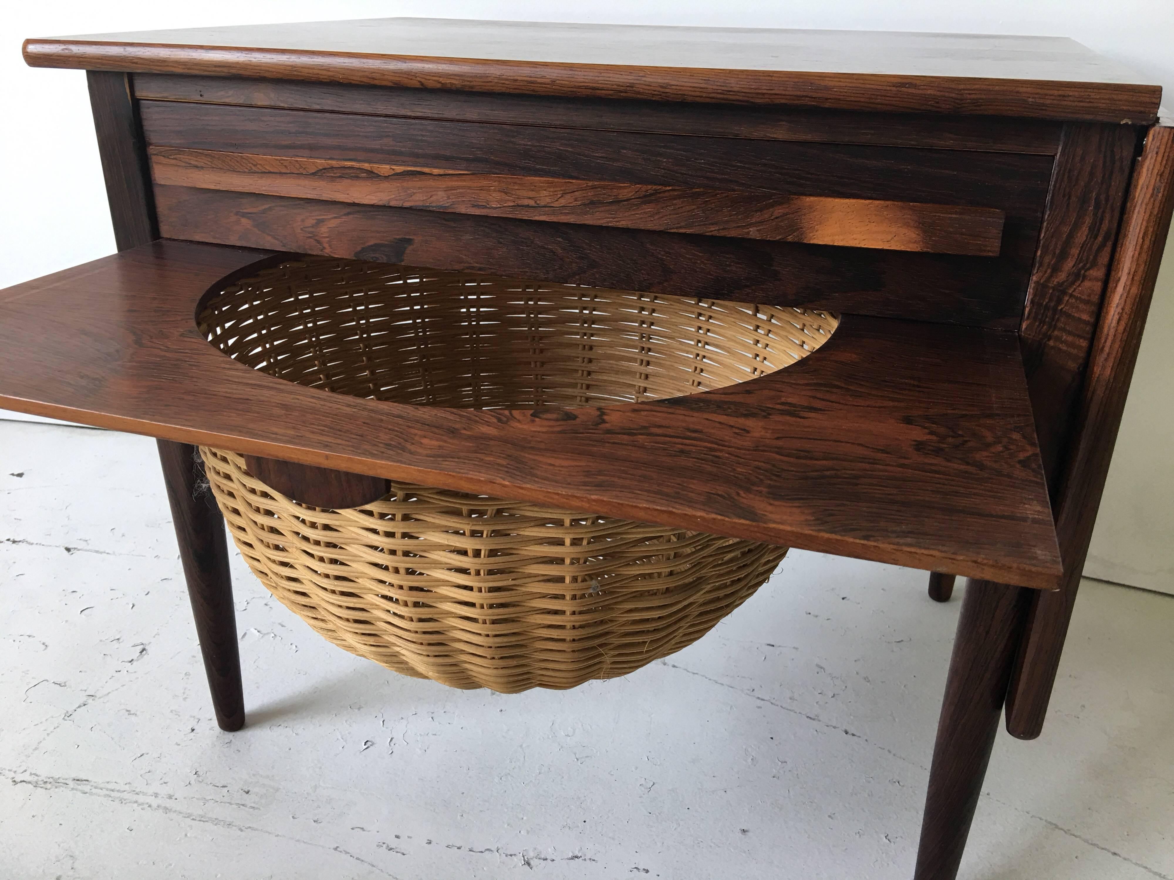 What a great versatile piece! This vintage rosewood sewing table features a drop-leaf that flips up and slides sideways making the top 36