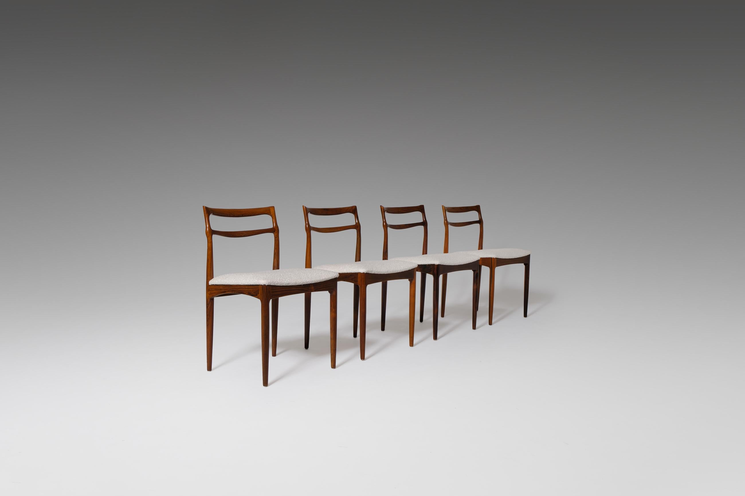 Elegant set of four dining chairs by Johannes Andersen, produced by the Christian Linneberg Møbelkfabrik, Denmark, 1960s. The chairs have a beautiful sculptural carved solid rosewood frame and show a variety of interesting details, such as the