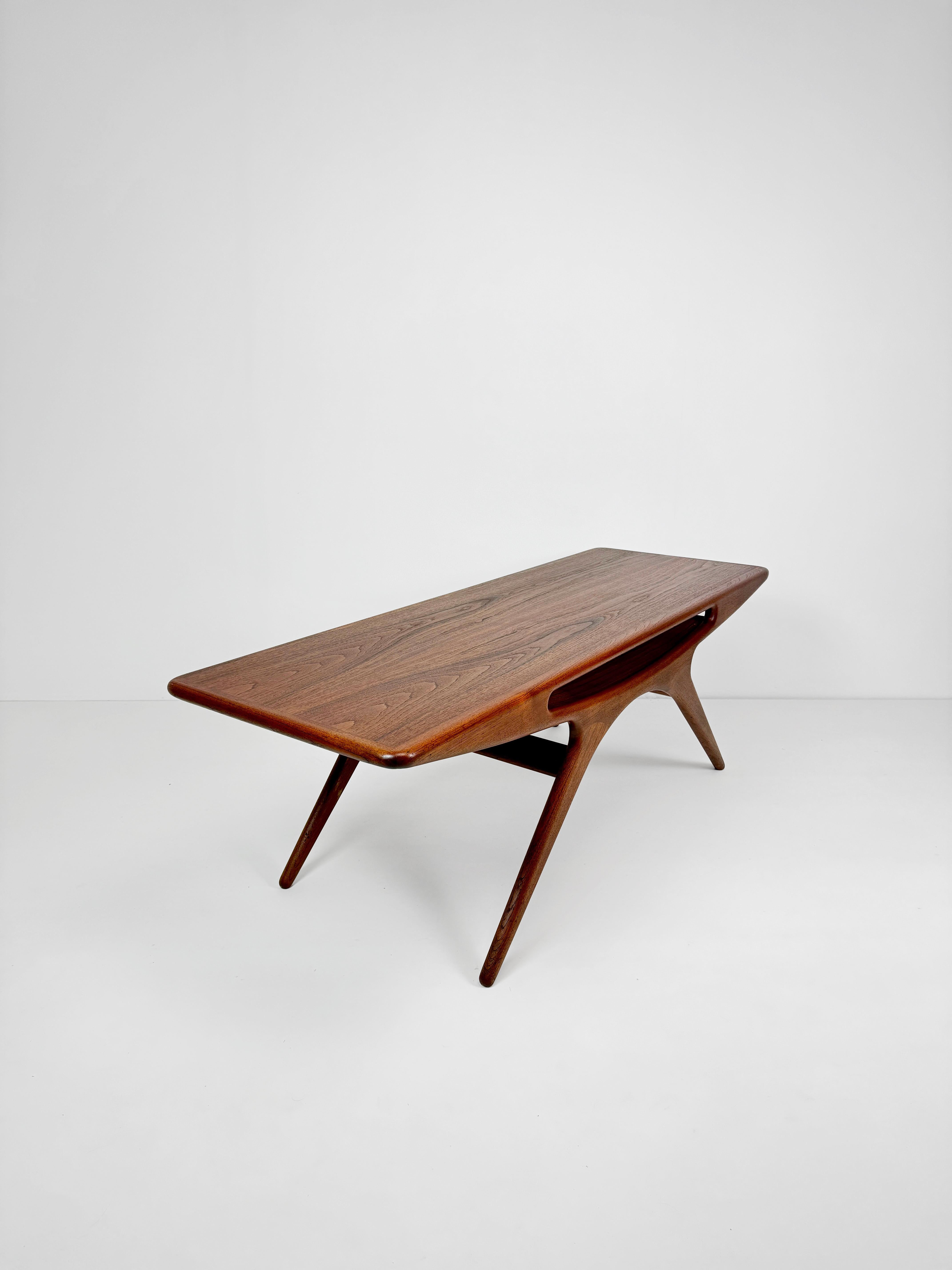 Johannes Andersen's Teak smile coffee table is one of the most iconic Danish coffee table designs of the 1950's and 60's. the organic form and proportions work together to create a beautiful object of art. the book matched Rosewood grain on the