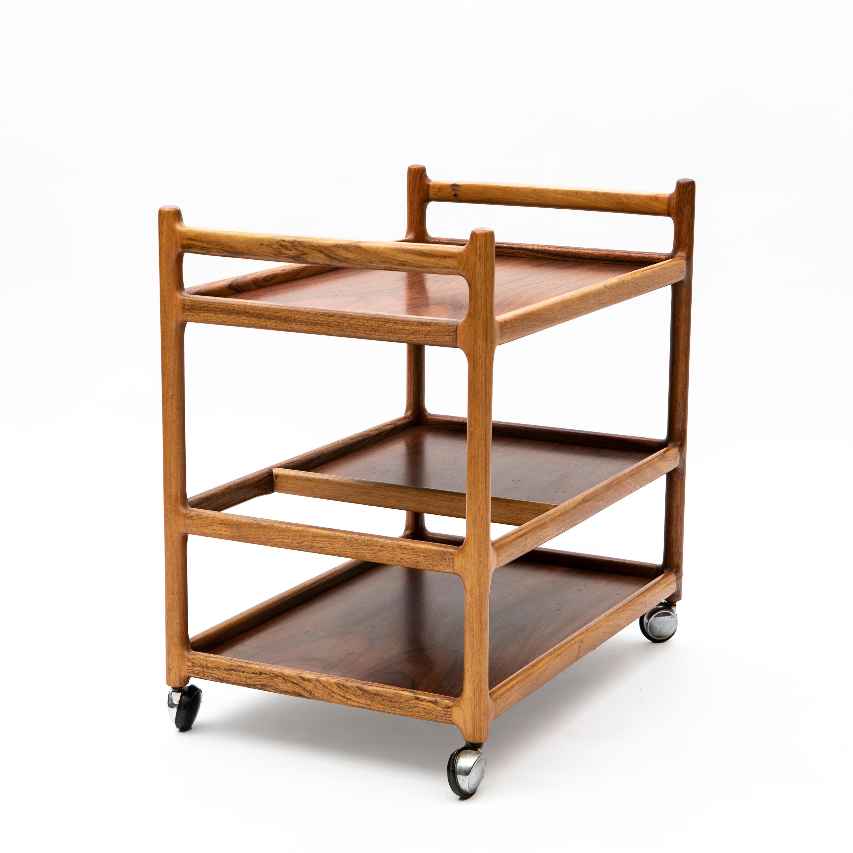 Serving trolley / bar cart with shelves designed by Johannes Andersen.
Constructed in rosewood set on chromed casters for easy movement.
Produced by CFC Silkeborg in Denmark, 1960's.

In very good original vintage condition with great