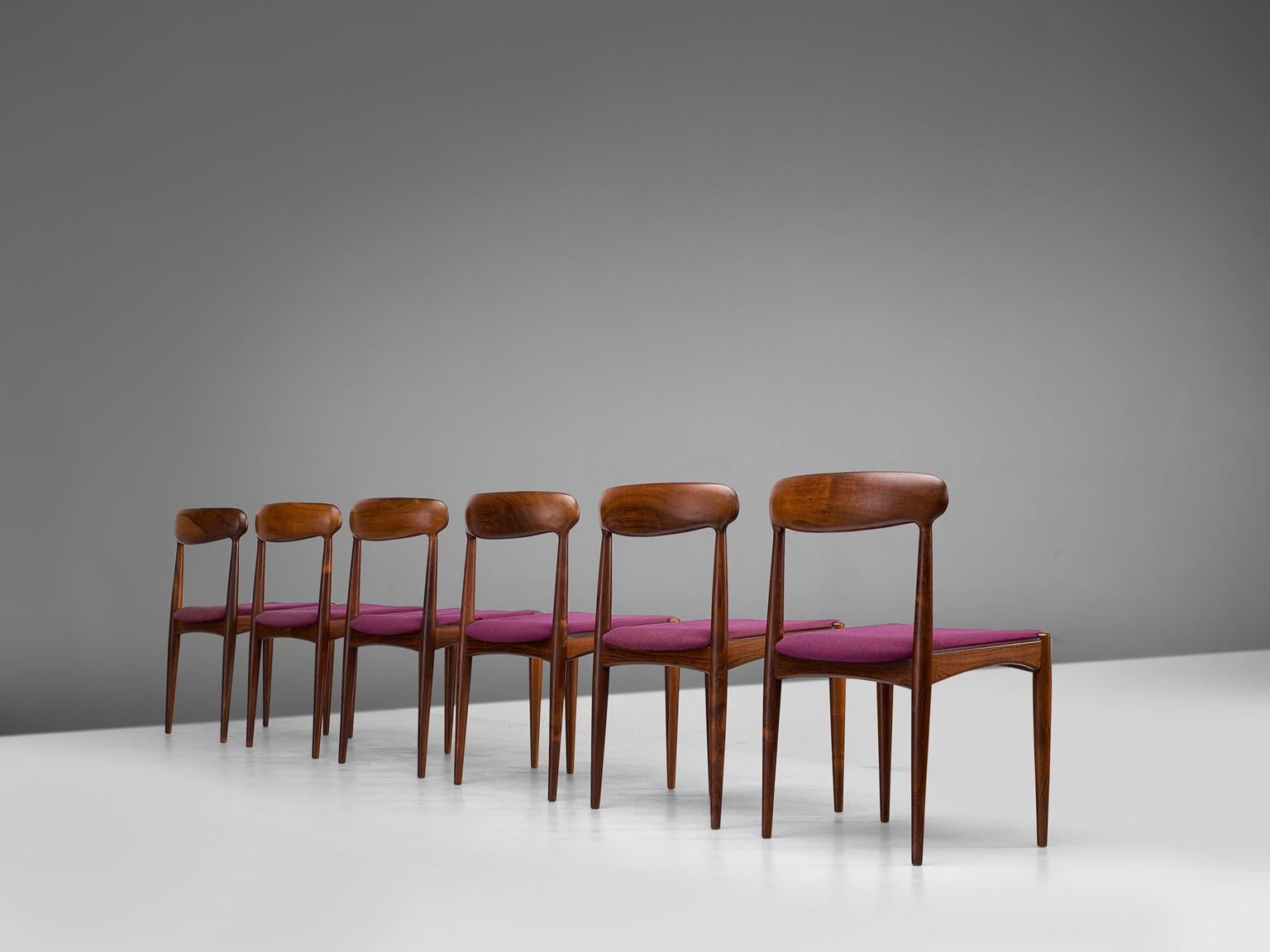 Dining room chairs, rosewood, purple fabric by Johannes Andersen and manufactured Uldum furniture factory, Denmark,1960s.

The restrained chic rosewood dining chairs are soft and warm in their appearance. The backrest is slightly tilted and