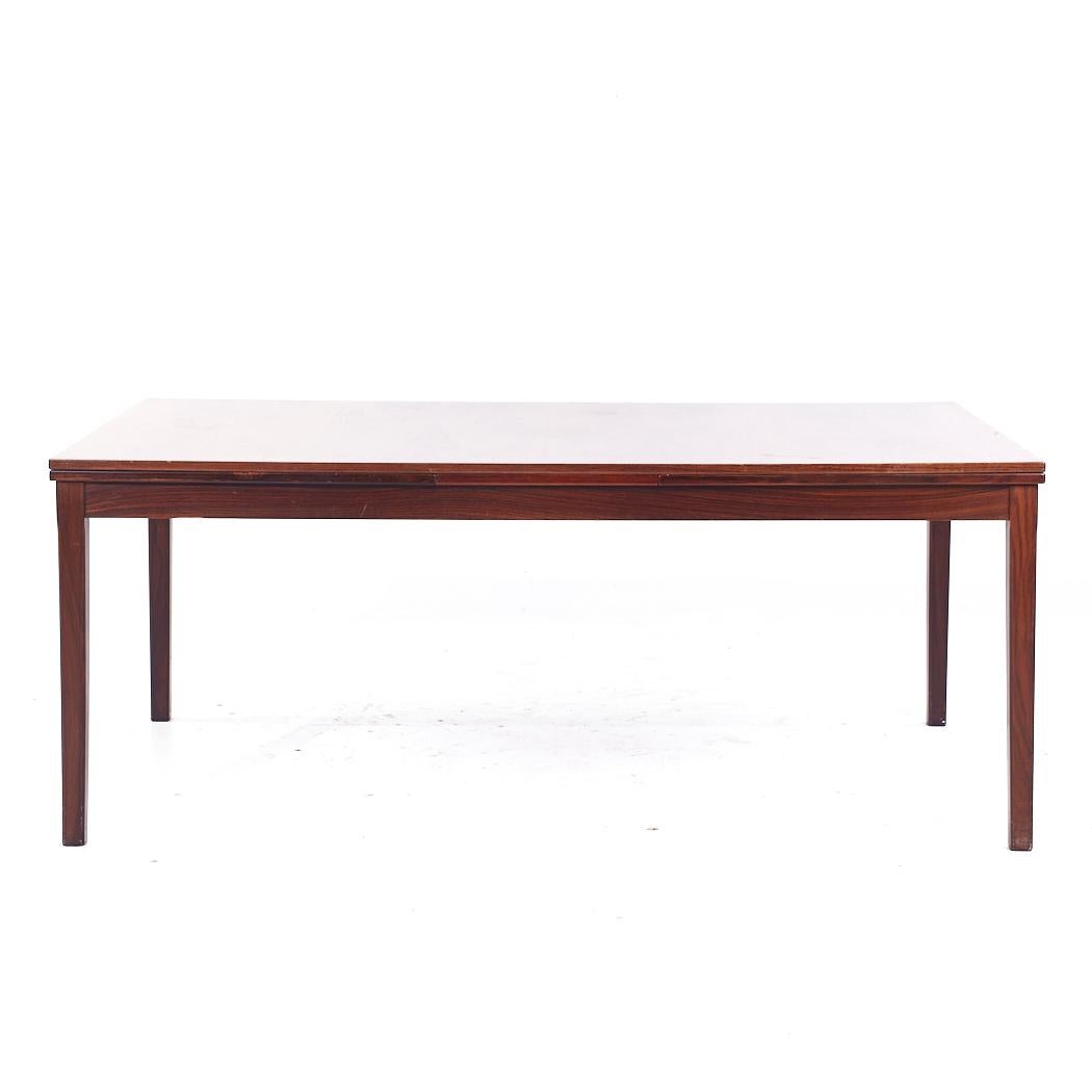 Johannes Andersen Style Mid Century Danish Rosewood Hidden Leaf Dining Table

This table measures: 71 wide x 40.25 deep x 28.5 inches high, with a chair clearance of 24 inches, each hidden leaf measures 27.5 inches wide, making a maximum table width