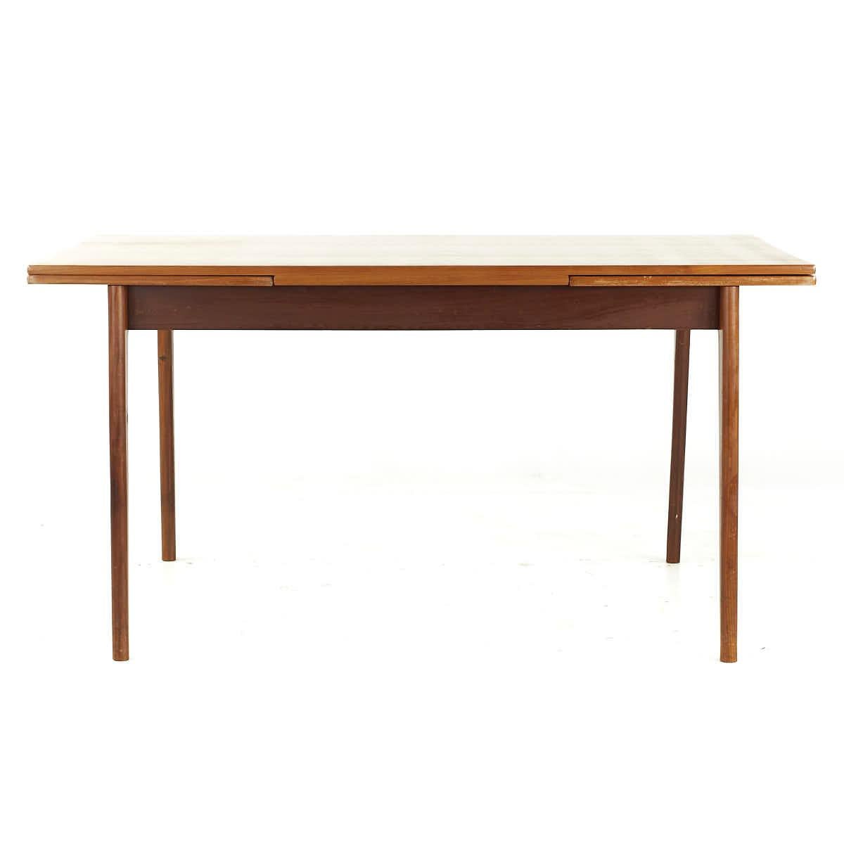 Johannes Andersen Style Mid Century Teak Hidden Leaf Dining Table

This table measures: 59 wide x 35.5 deep x 30 inches high, with a chair clearance of 24.75 inches, each leaf measures 18.5 inches wide, making a maximum table width of 96 inches when