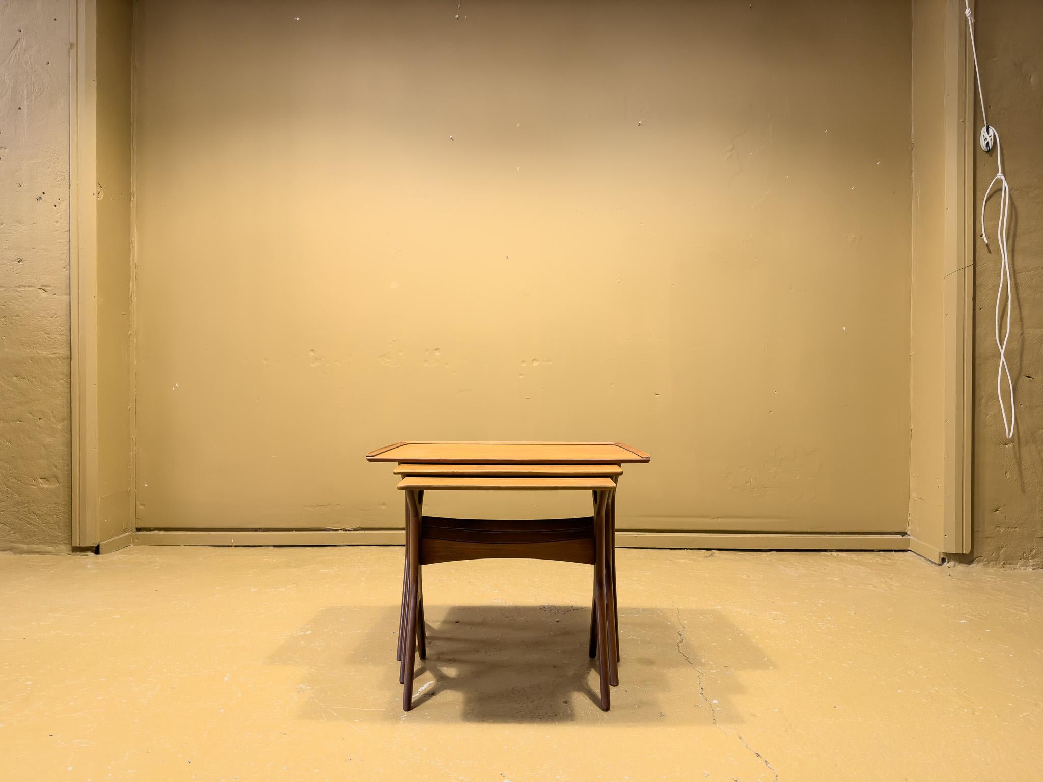 This exceptional set of nesting tables, designed by Johannes Andersen for CFC Silkeborg in the 1960s, are crafted from richly grained teak, and feature a sculptural form, with sleek, organic lines making them a seamless blend of function and