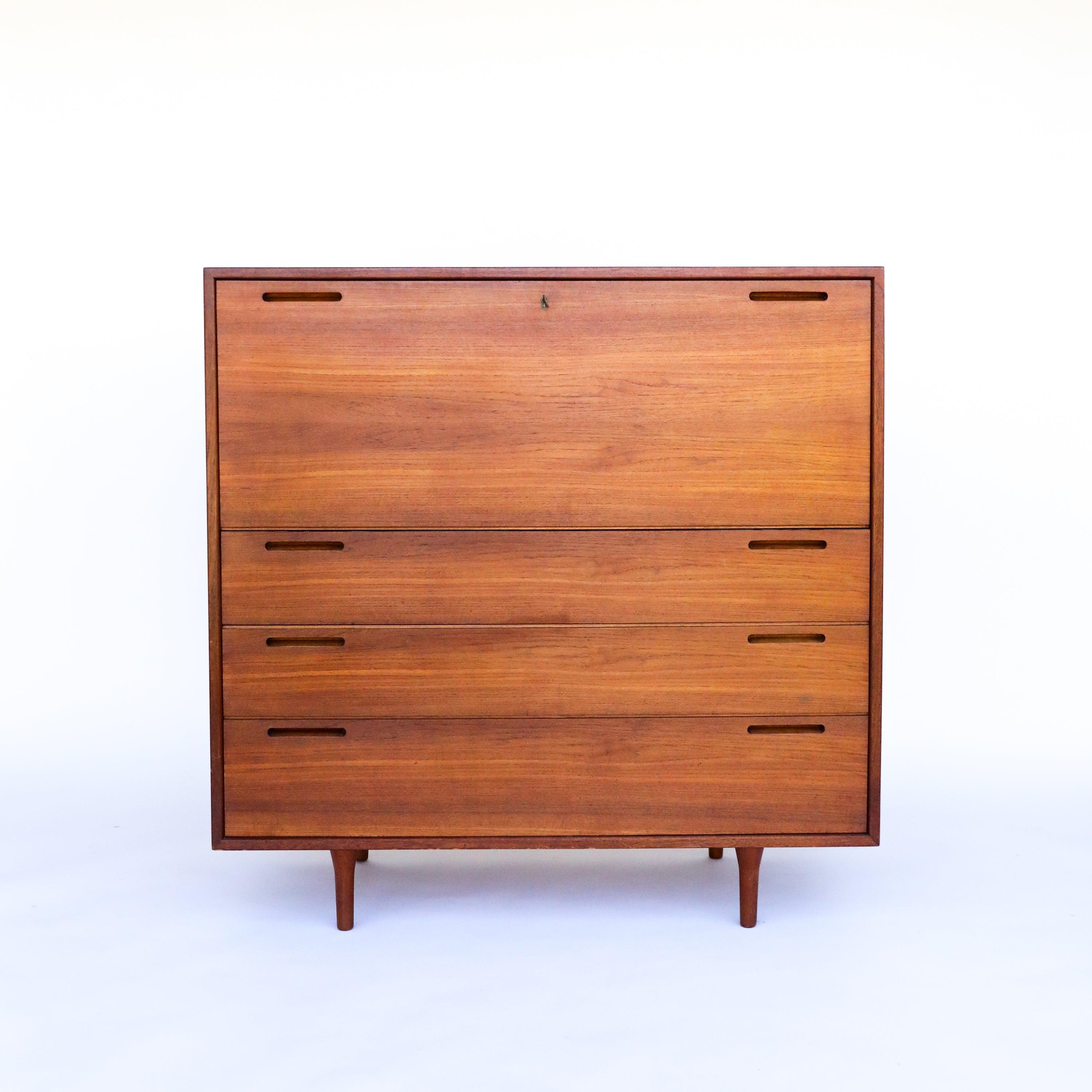This is an understated teak secretary desk constructed in the 1950's by Johannes Andersen . It is in excellent vintage condition. would be great for an entryway or used as a desk. It boasts gorgeous old-growth teak and finger pull that add to its