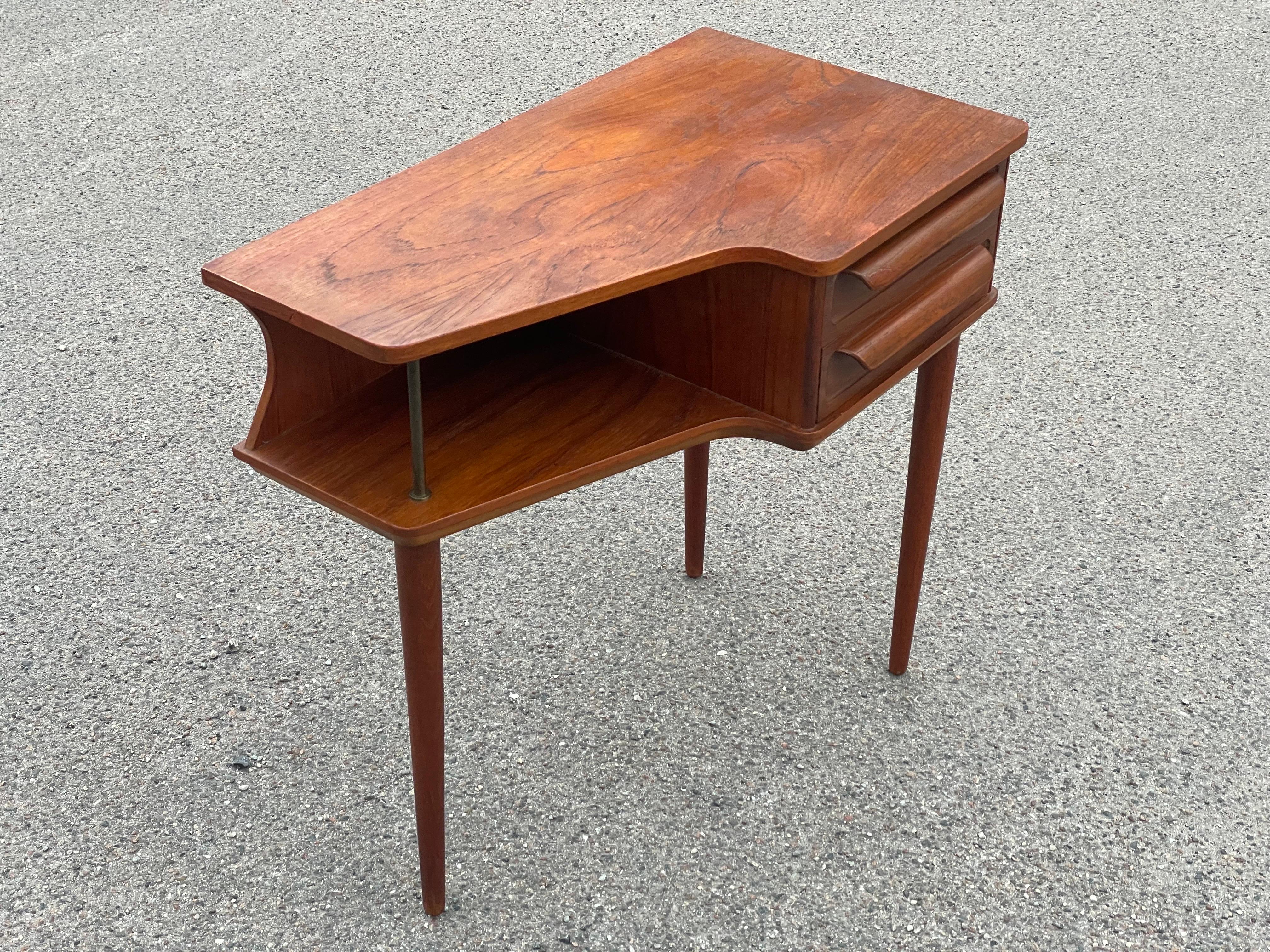 Exquisite find for enthusiasts of mid-century design: an Early Johannes Andersen Teak Side Table from 1960. This rare gem boasts an early CFC Silkeborg brandmark underneath, a testament to its authentic vintage origins. With its distinctive three