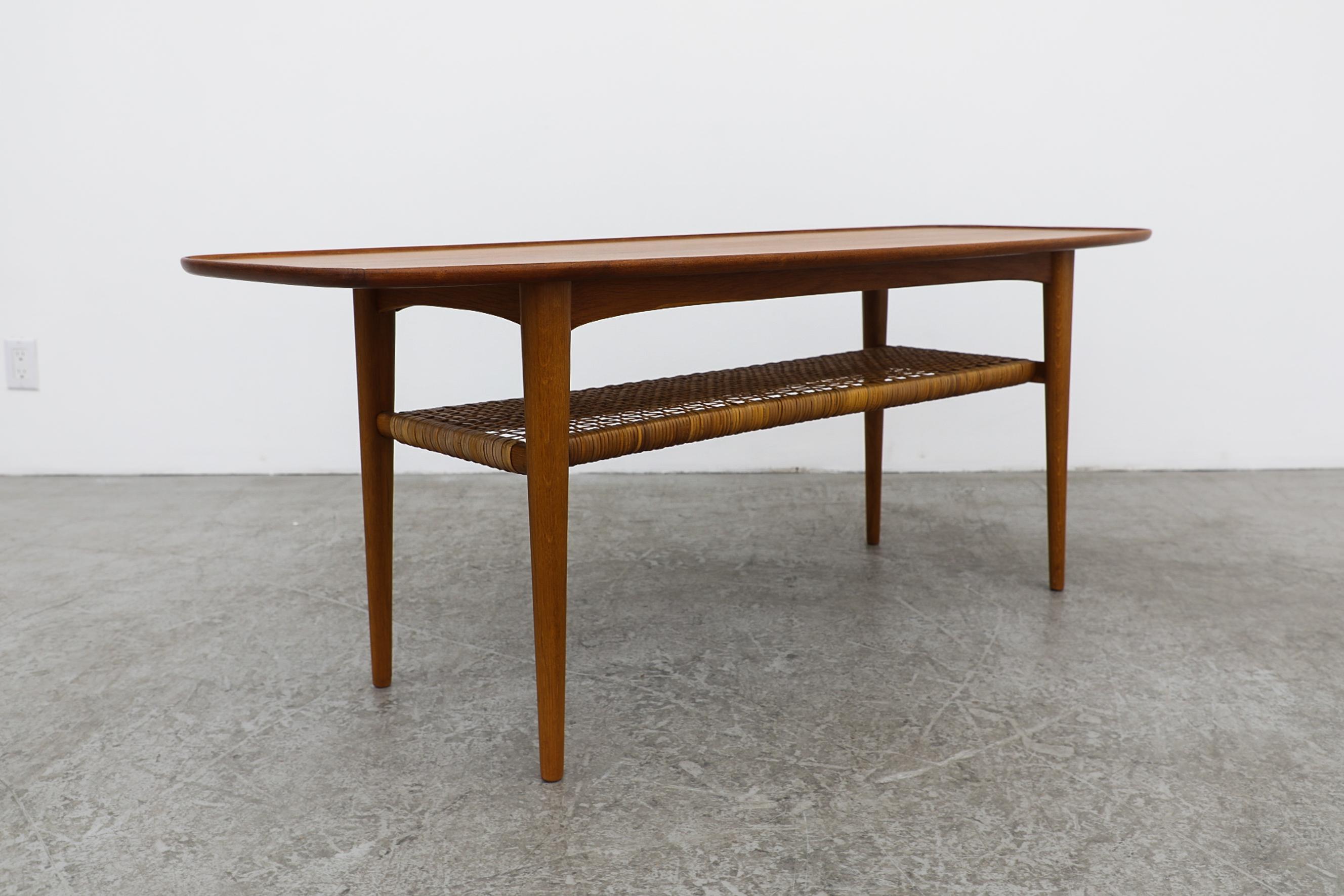 Mid-Century Modern Johannes Anderson Rounded Danish Teak Coffee Table w/ Lip & Lower Rattan Shelf For Sale