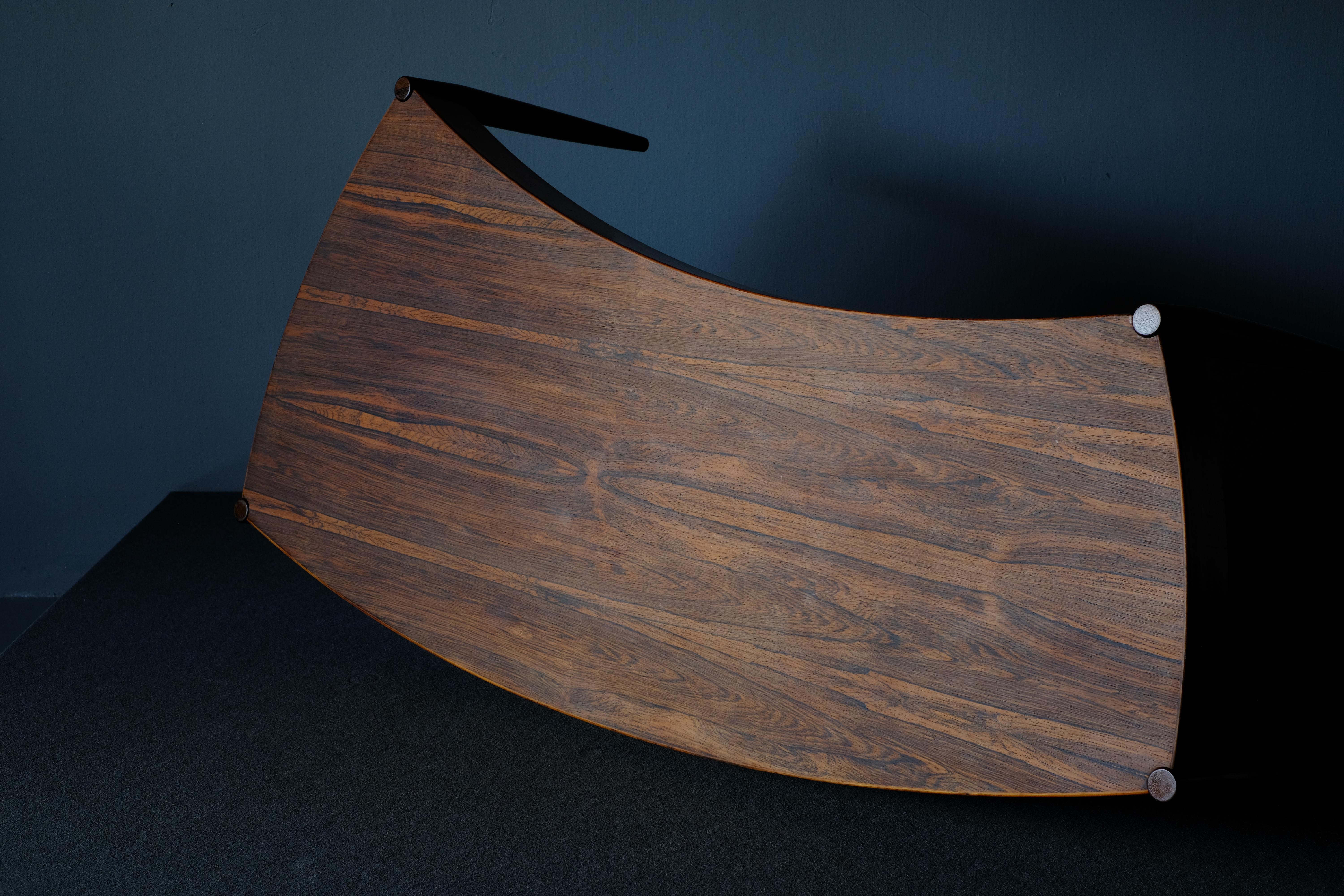 Really unique curved coffee table. It has sculptural lines and elegant tapering legs. It was designed in the 1960s by Johannes Anderson and produced by Trensum. The wood has a lovely grain and it’s patina has been allowed to develop. Quite the