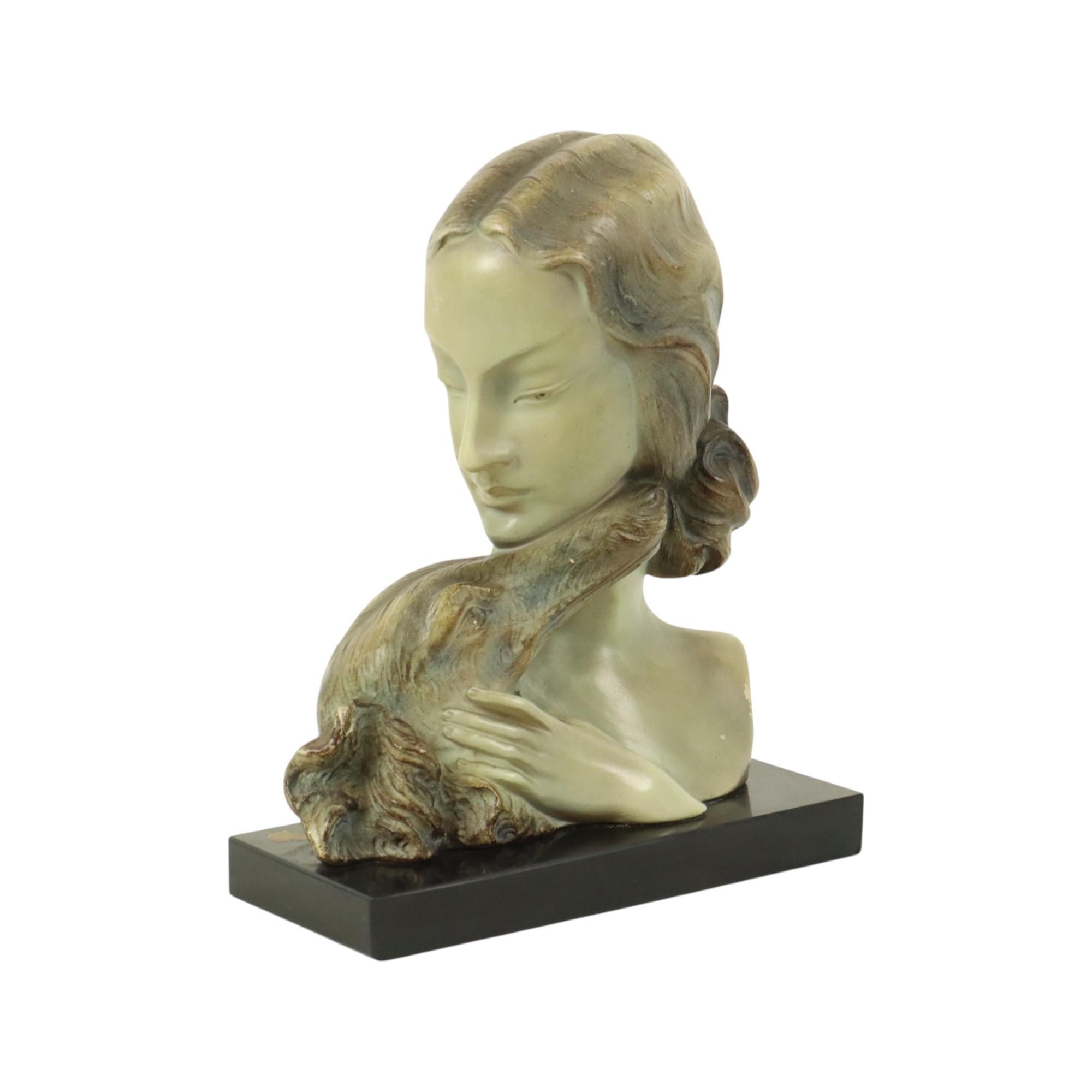 Beautiful art deco bust of a lady with a Borzoi hunting dog, made of patinated plaster with a marble base, made and signed and numbered on the back by Johannes Domisse 2324, Belgium circa 1930.

Johannes Domisse was an artist and lived from 1878 to